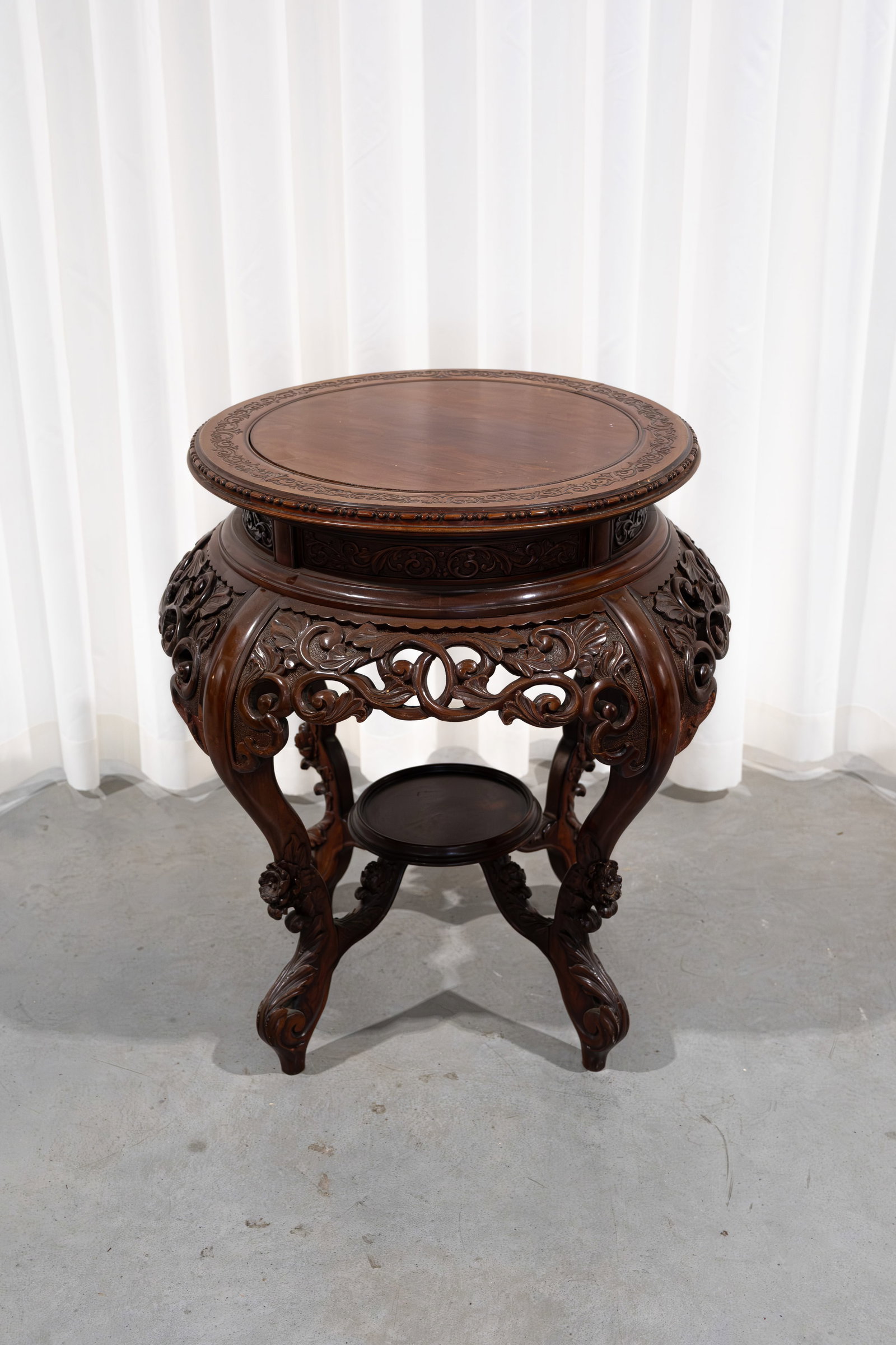 A Chinese imposing carved wooden richly decorated round pedestal (1 of 9)