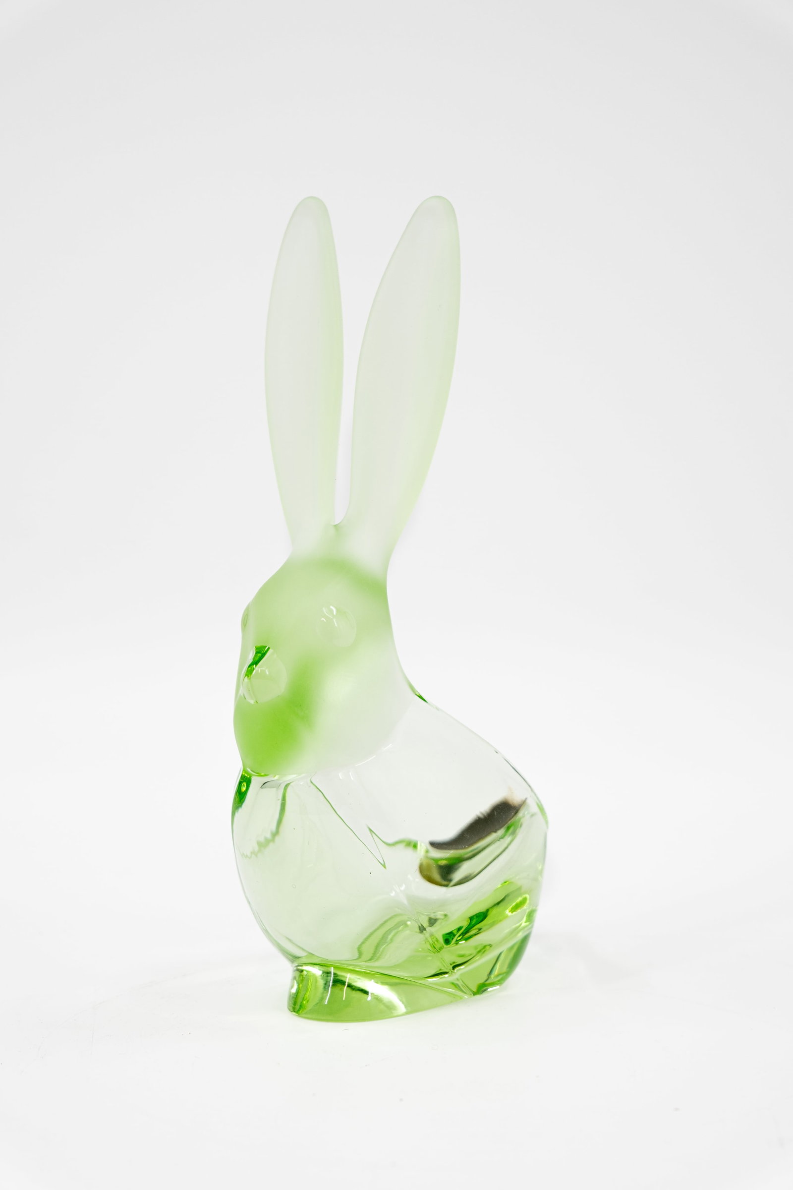 A vintage green uranium glass rabbit mounted into an ashtray: A vintage green uranium glass rabbit mounted into an ashtray, probably Vannes Le Chatel. 20th century. H: 22 cm