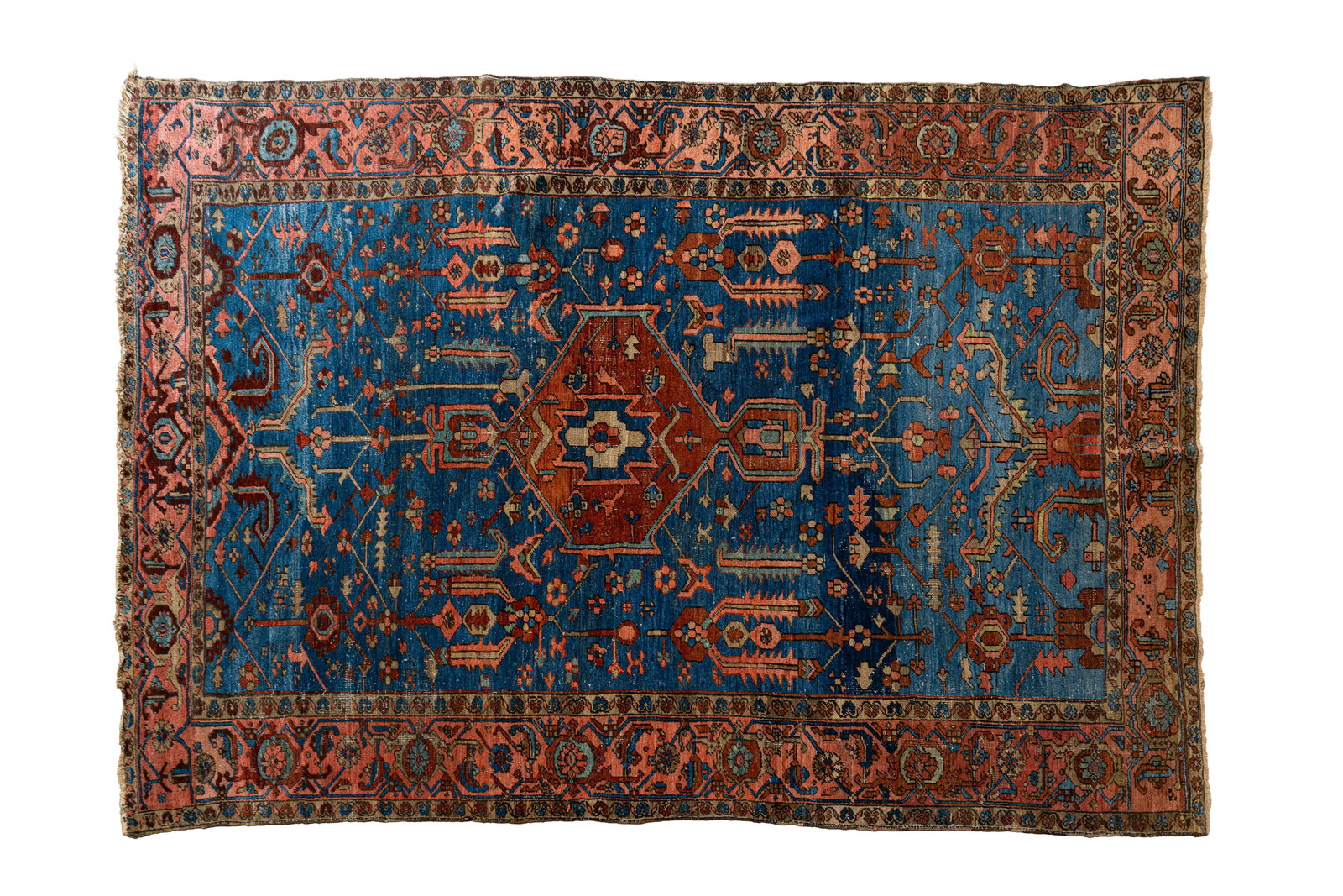 A large and antique hand-knotted Persian wool rug: A large and antique hand-knotted Persian wool rug decorated with a large central medallion and angular geometric motifs on a blue field. Iran, probably Heriz, early 20th century. L: 374 - W: 268 cm