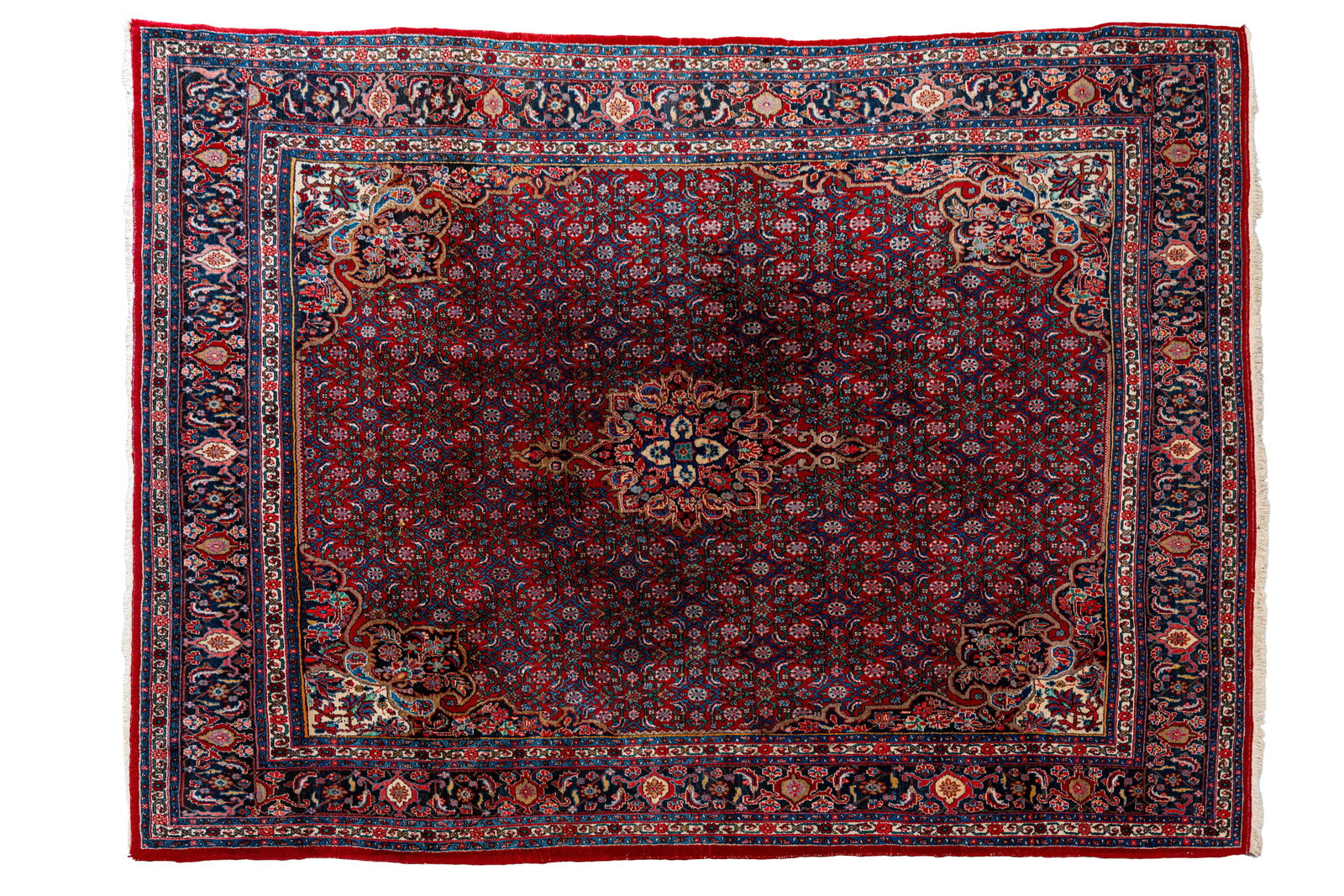 A large and hand-knotted Persian wool rug decorated with a small central floral medallion (1 of 12)
