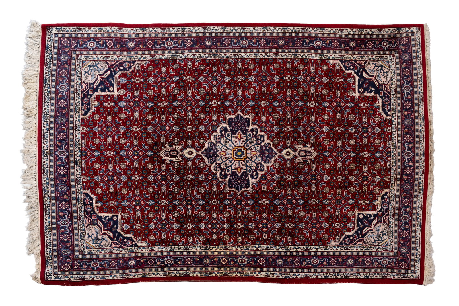 A hand-knotted Persian wool rug decorated with a central floral medallion (1 of 11)