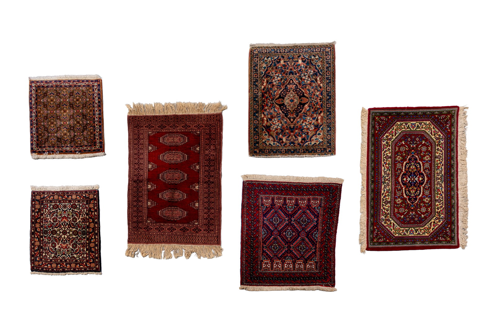 A lot of six small hand-knotted Oriental wool rugs, variously decorated (1 of 16)