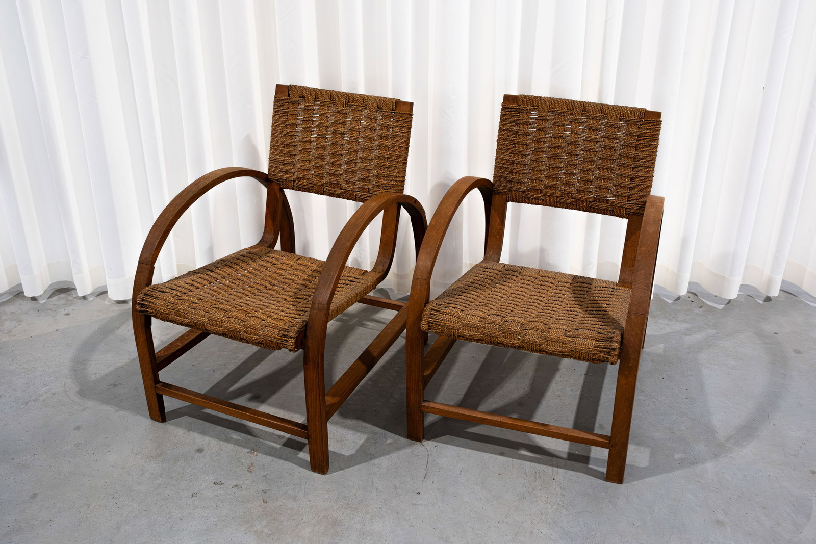 A matching pair of vintage armchairs with woven seats and backs (1 of 9)