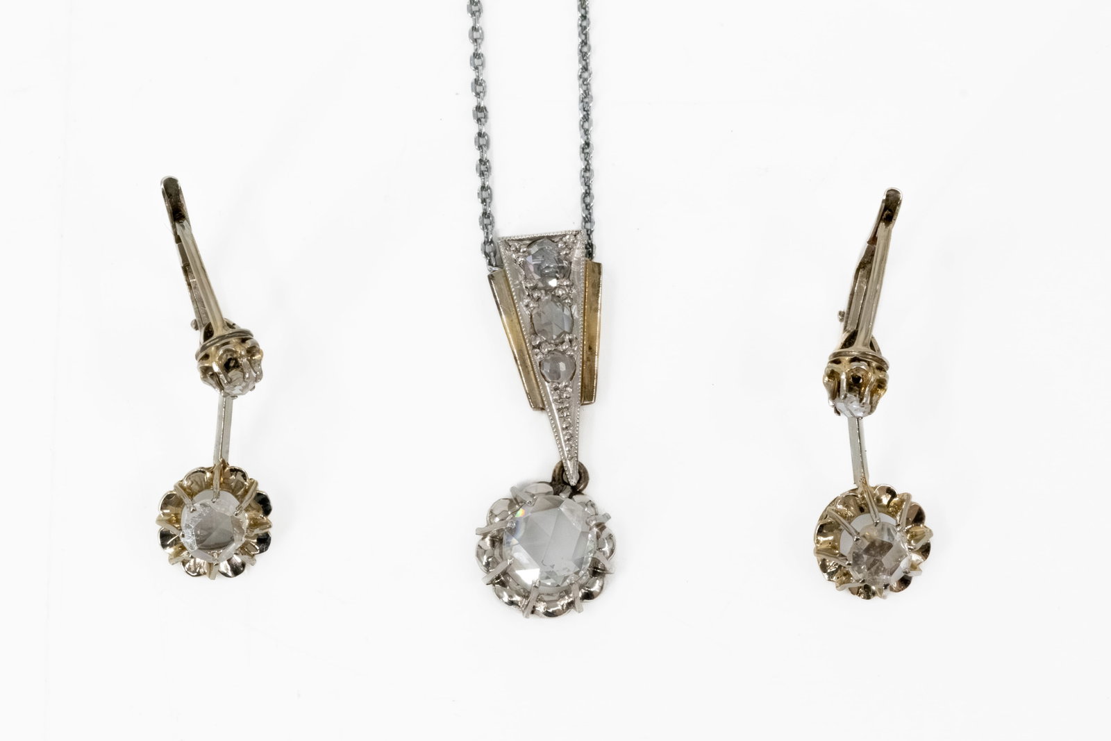 An antique art deco style platina jewelry set with mounted old cut diamonds: An antique art deco style platina jewelry set with mounted old cut diamonds. Consisting of: one necklace and a pair of earrings. Circa 1900-1920s. Total weight: 5,9g