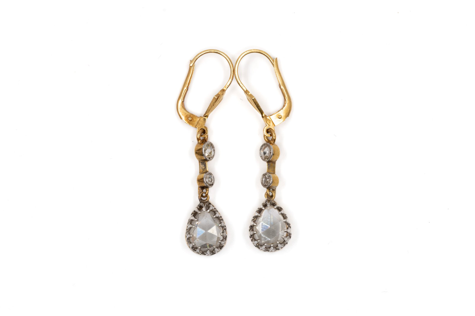 A pair of 18k gold and rose-cut diamonds pendant earrings: A pair of gold 18k and rose-cut diamonds pendant earrings. Each earring set with two small rose-cut stones above a pear-shaped rose-cut stone drop, with gold hook fittings. Total weight: 3,3g