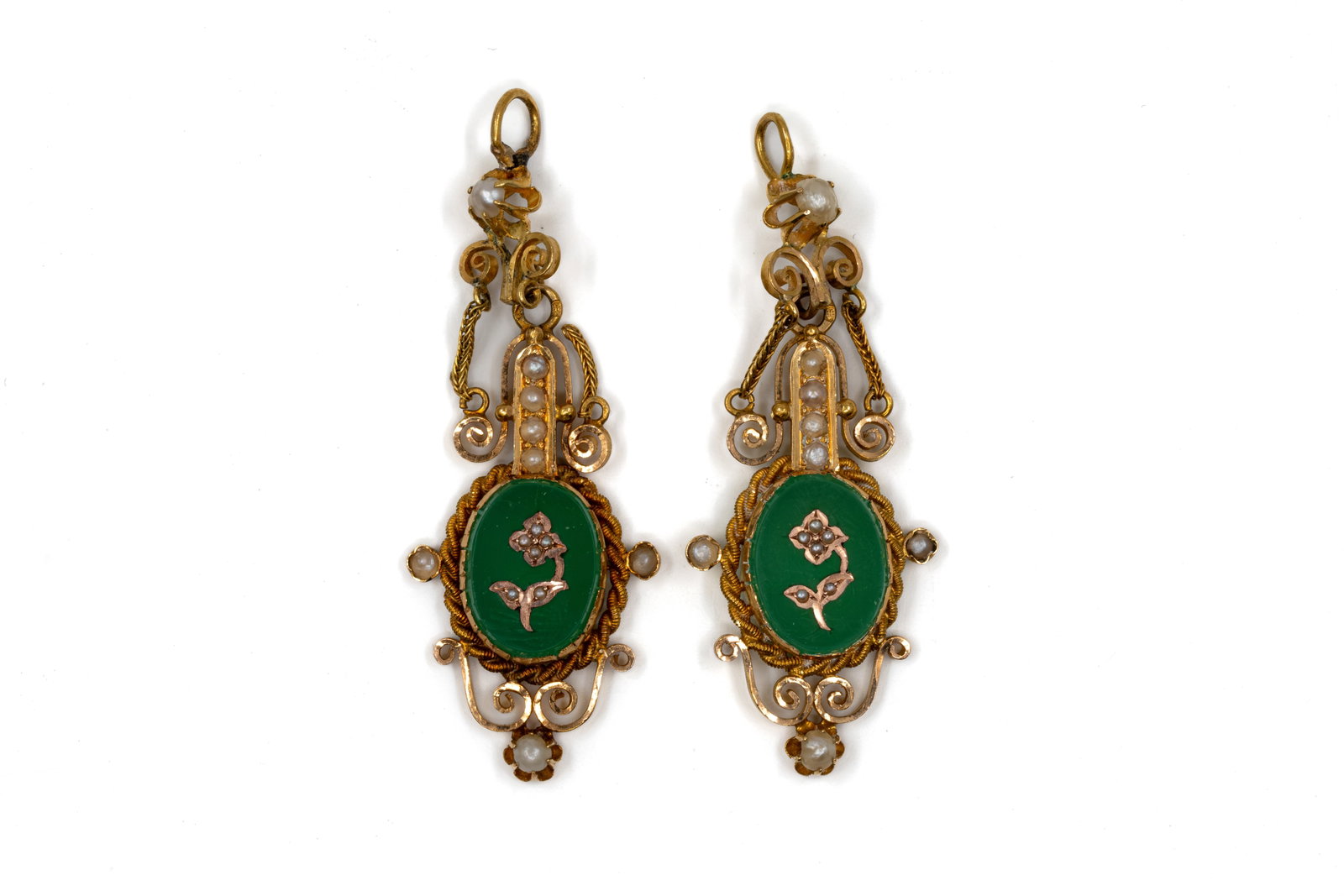 A lot of two gold jewelry elements with green cabochons and seed pearls: A lot of two gold jewelry elements with green cabochons and seed pearls. Two gold pendant jewellery elements, each set with an oval green cabochon, within a rope-twist border, decorated with scrolling