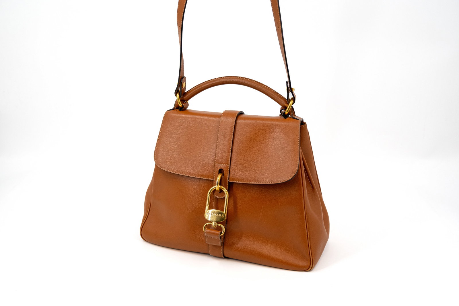 A Delvaux bag model Gin Fizz in fauve leather: A Delvaux bag model Gin Fizz in fauve leather with gold-toned hardware. Condition: this bag has been used but remains in a neat condition with some usage marks and corner damage, interior shows some p