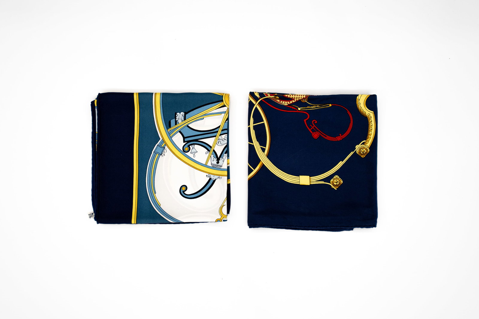 A composed lot of two Classic Carré Hermes scarves with carriages designs: Lot 252. A composed lot of two Classic Carré Hermes scarves. Design "Washington's Carriage" designed by Caty Latham and "Springs" designed by Philippe Ledoux. Condition: "Washington's Carriage" comes