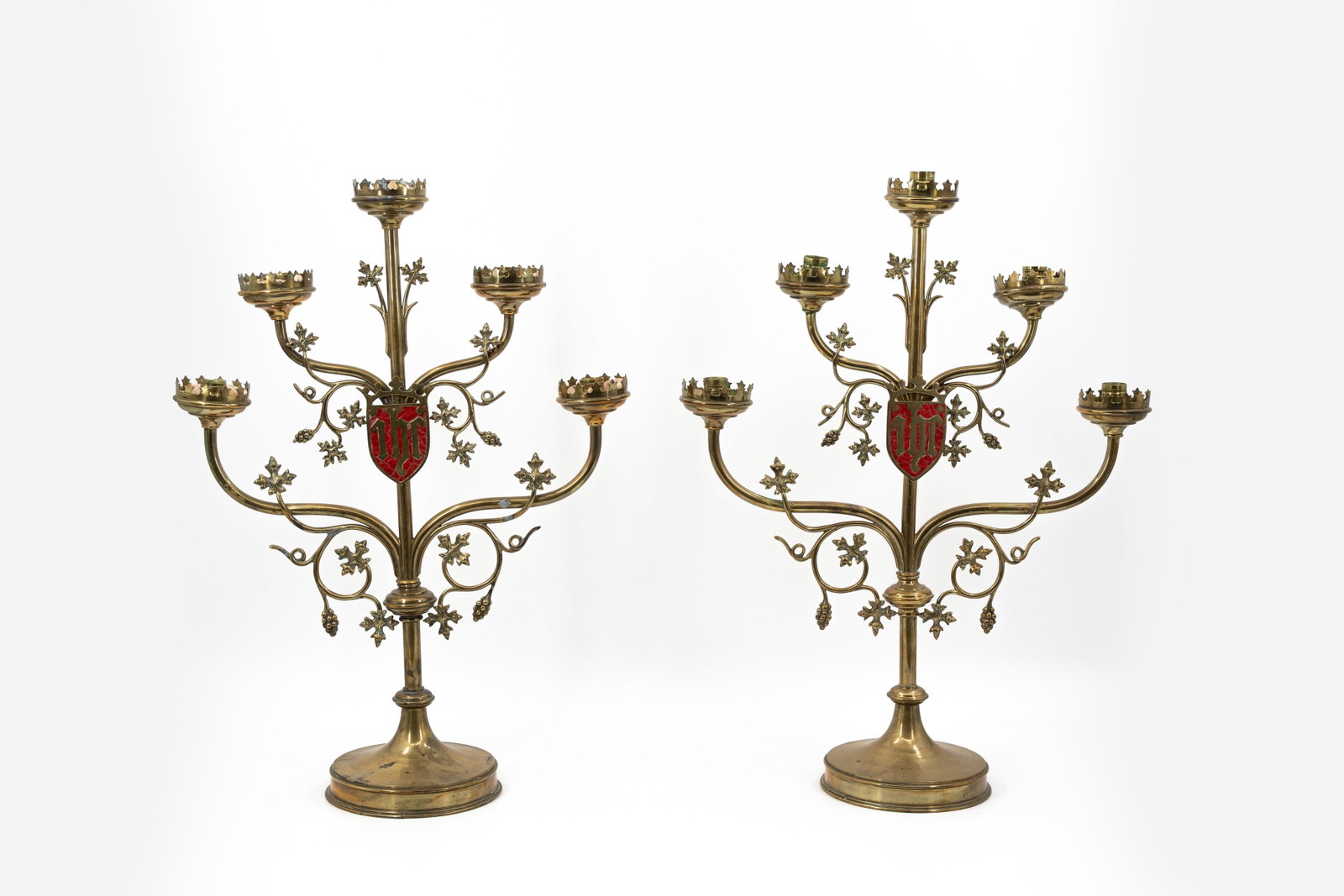An antique pair of Neo-Gothic style brass five-light religious candelabra: An antique pair of Neo-Gothic style brass five-light religious candelabra with foliage decoration. First half 20th century. H: 57,5 cm
