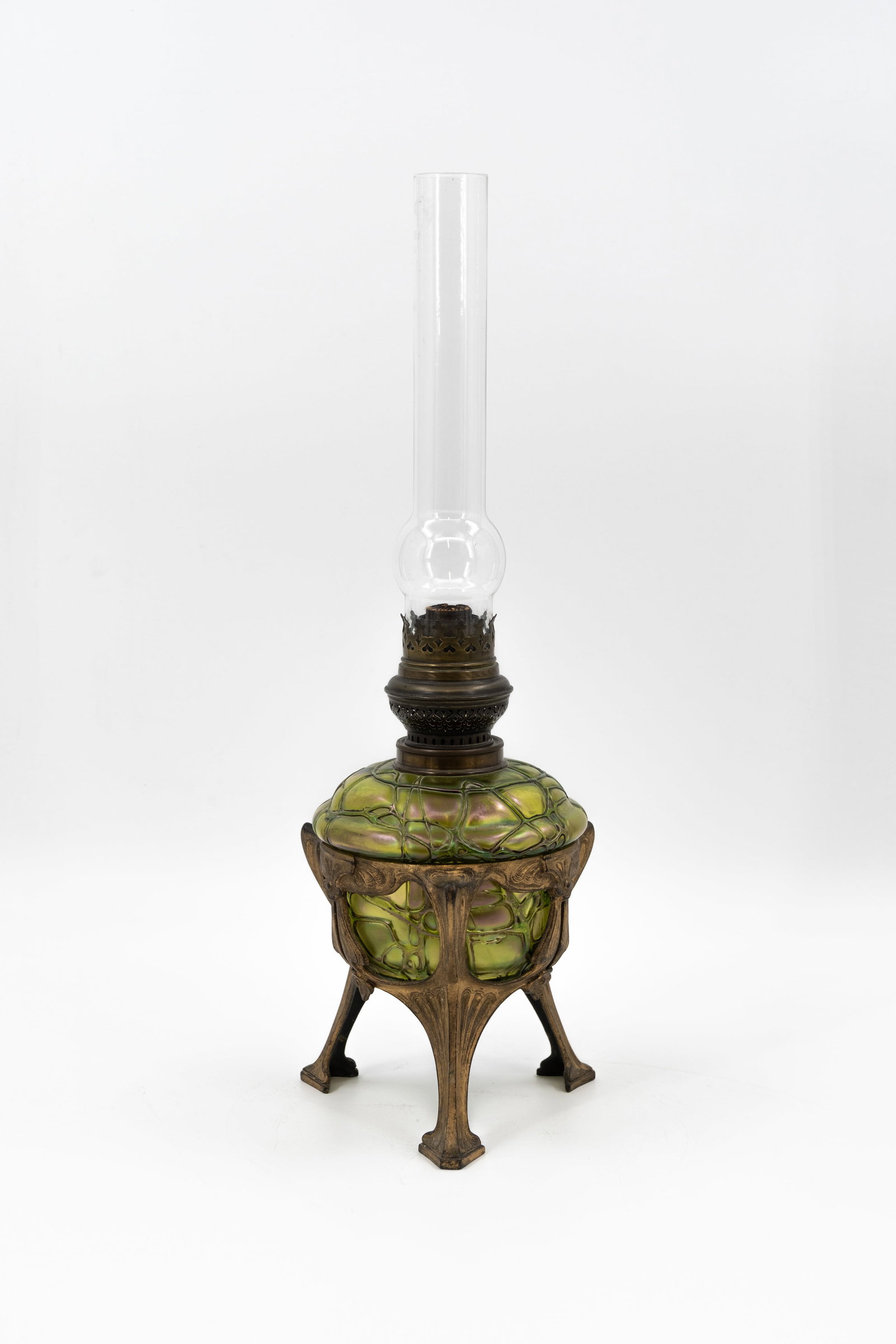 An antique art nouveau brass mounted glass oil lamp: An antique art nouveau brass mounted glass oil lamp, in the manner of Loetz. Circa 1900-1920s. H: 50 cm