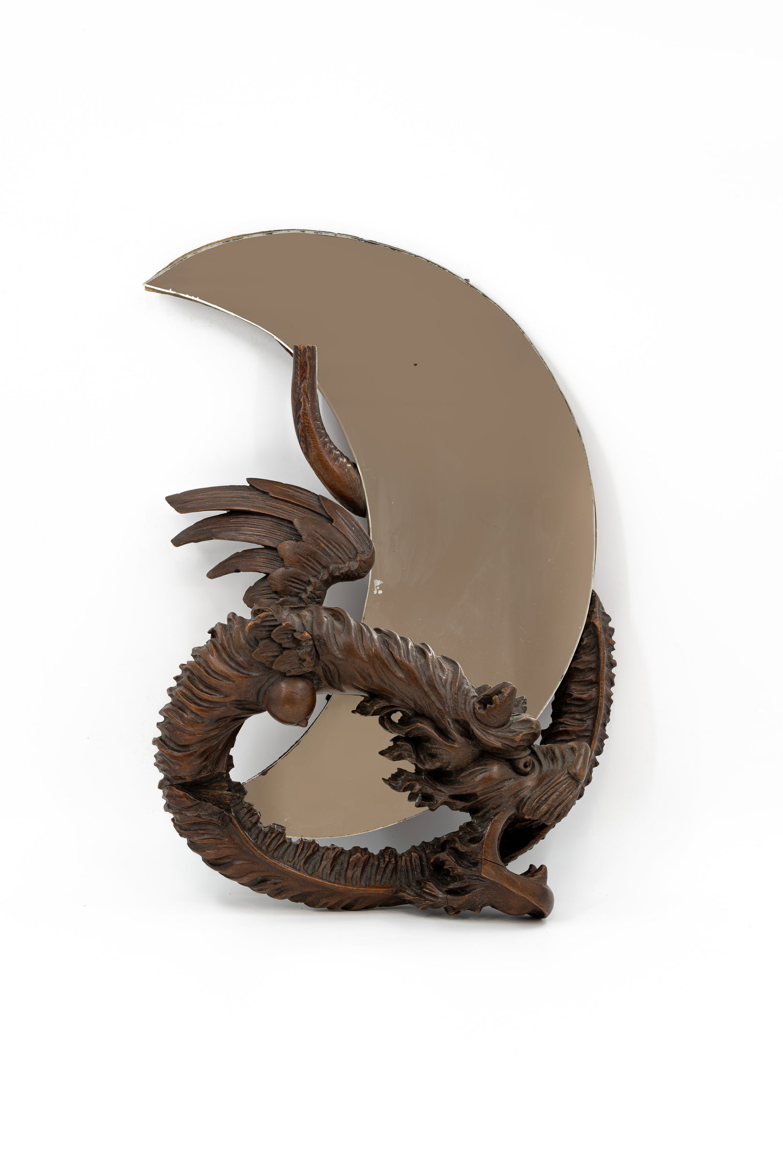 An antique, moon-shaped mirror mounted with a carved wooden dragon (1 of 8)