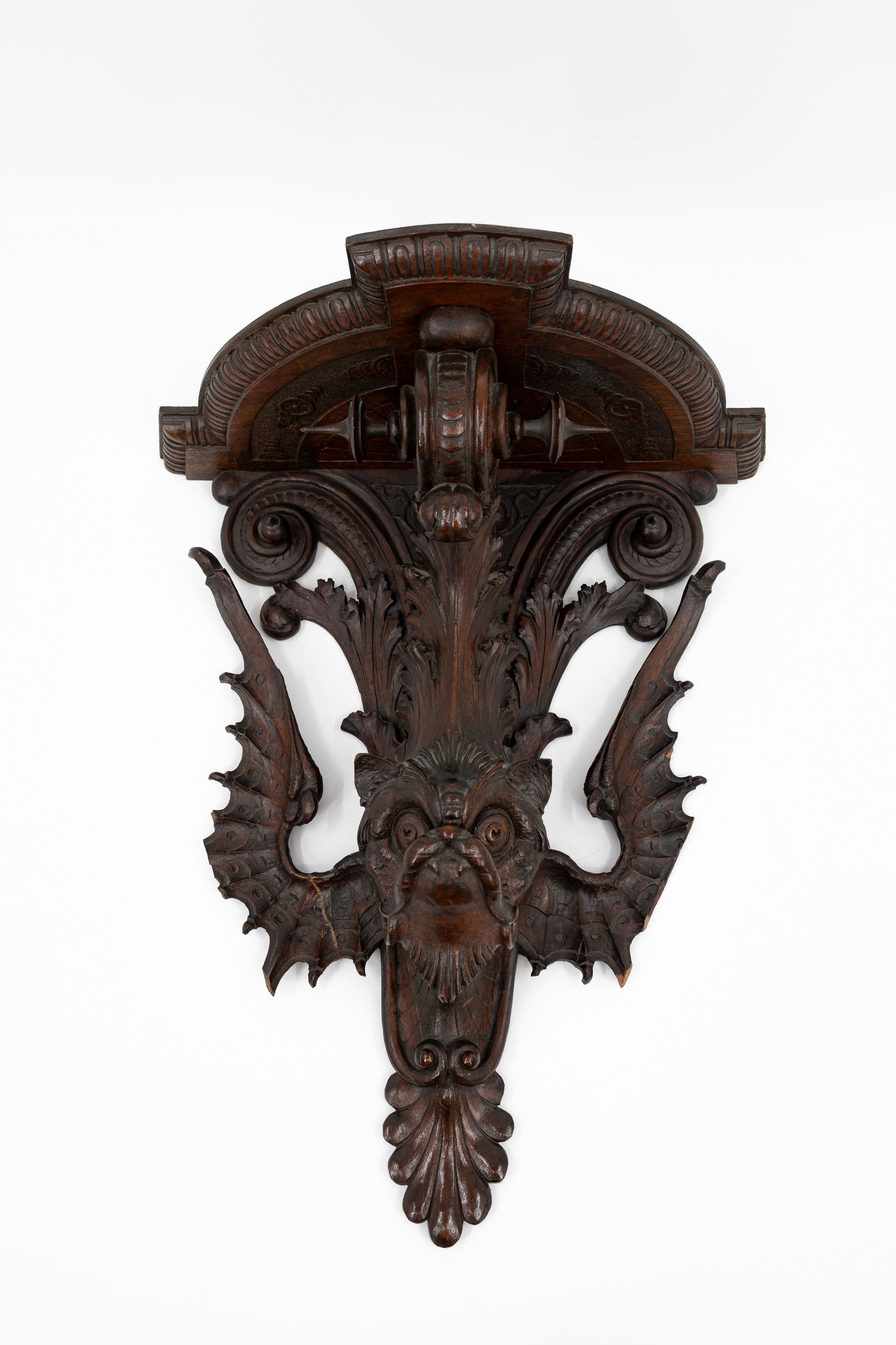 An antique carved wooden figural wall console: An antique carved wooden figural wall console sculpture with a unique winged figure. Probably Italy, circa 1900. H: 48 - W: 40 cm