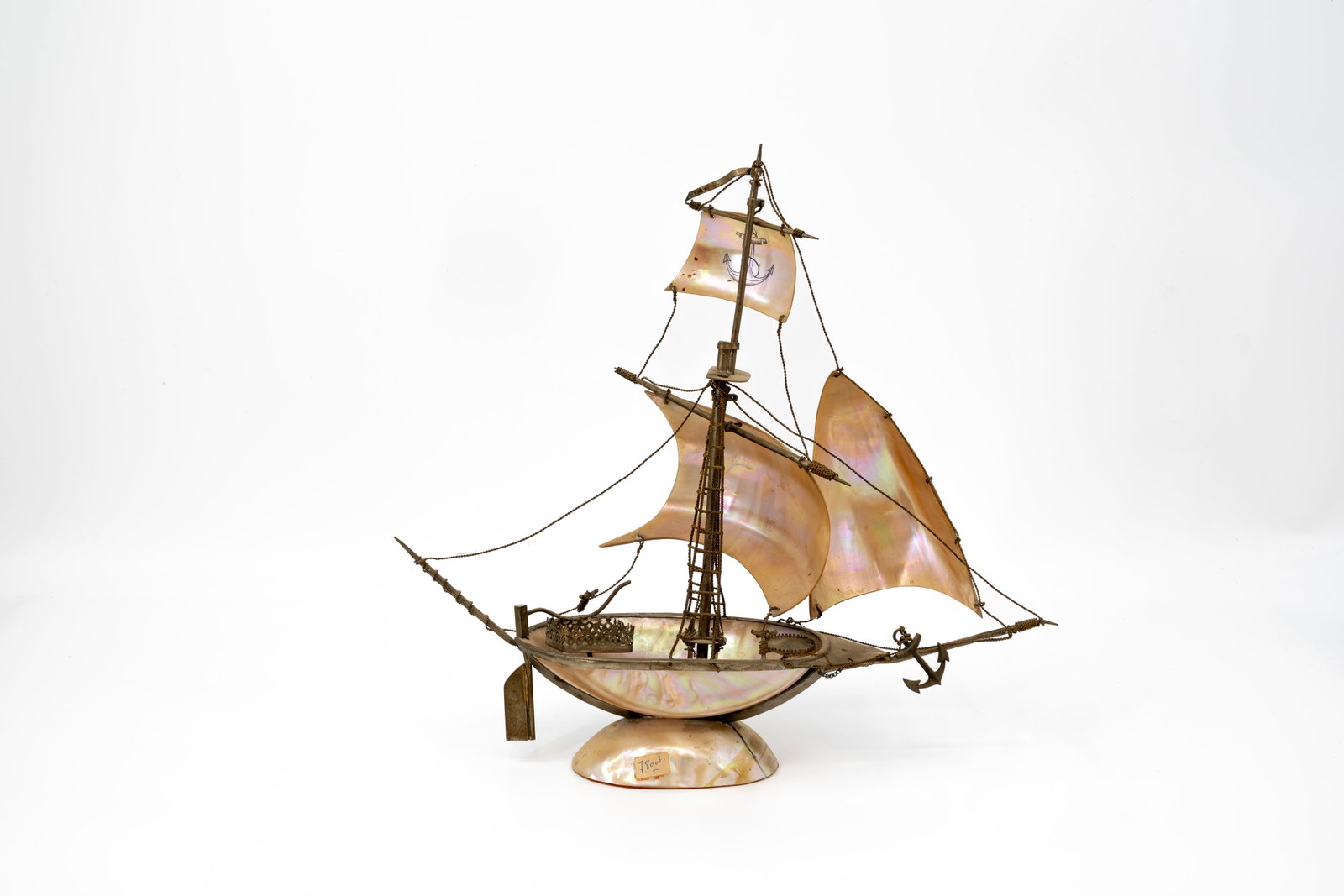 An antique brass mounted mother of pearl boat: An antique brass mounted mother of pearl boat. First half 20th century. H: 34 - W: 38 cm