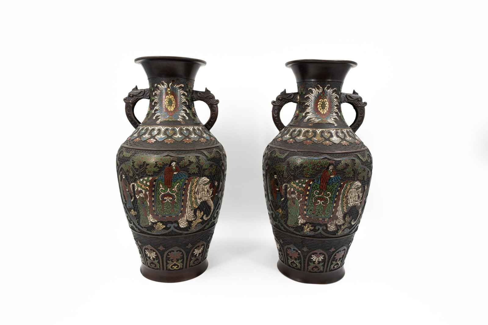 A pair of large Japanese cloisonne vases richly decorated with an elephant scene: A pair of large Japanese cloisonne vases with handles and richly decorated with an elephant scene. Late 19th century. H: 54 cm