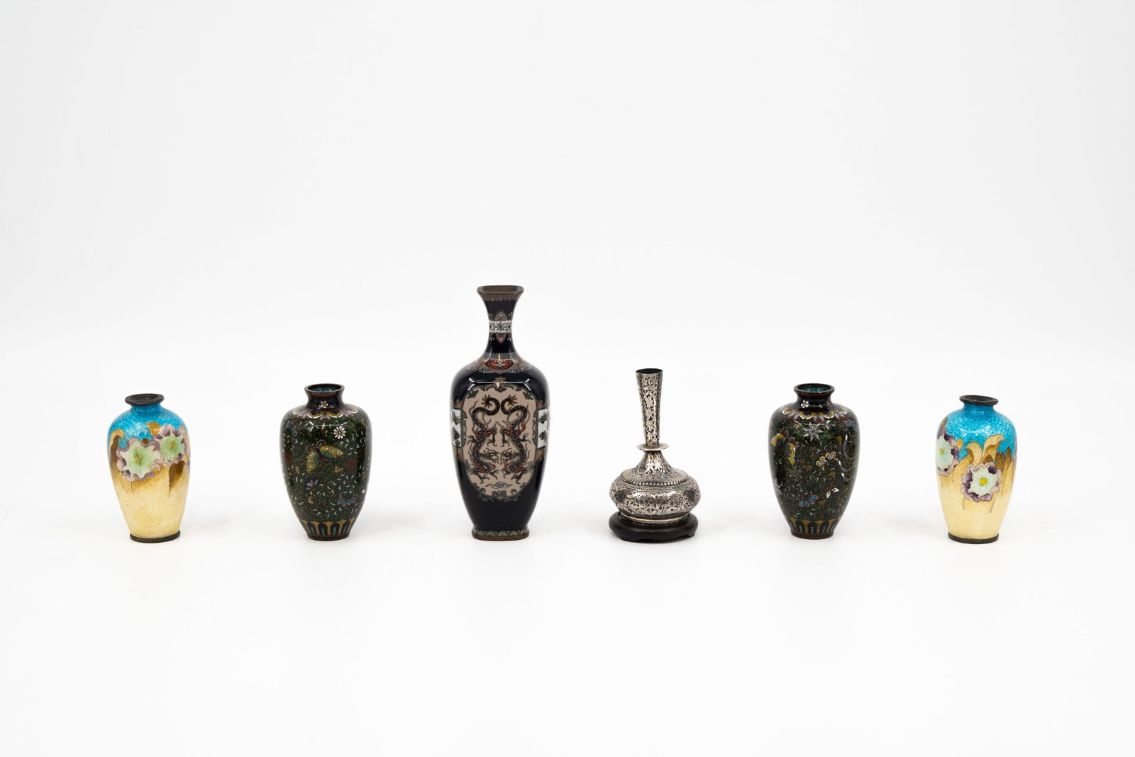 A composed lot of five Japanese cloisonne miniature vases, together with one oriëntal decorated: A composed lot of five Japanese cloisonne miniature vases, together with one oriëntal decorated vase. Meji period, circa 1900. H: 9 -15,5 cm, smallest to largest