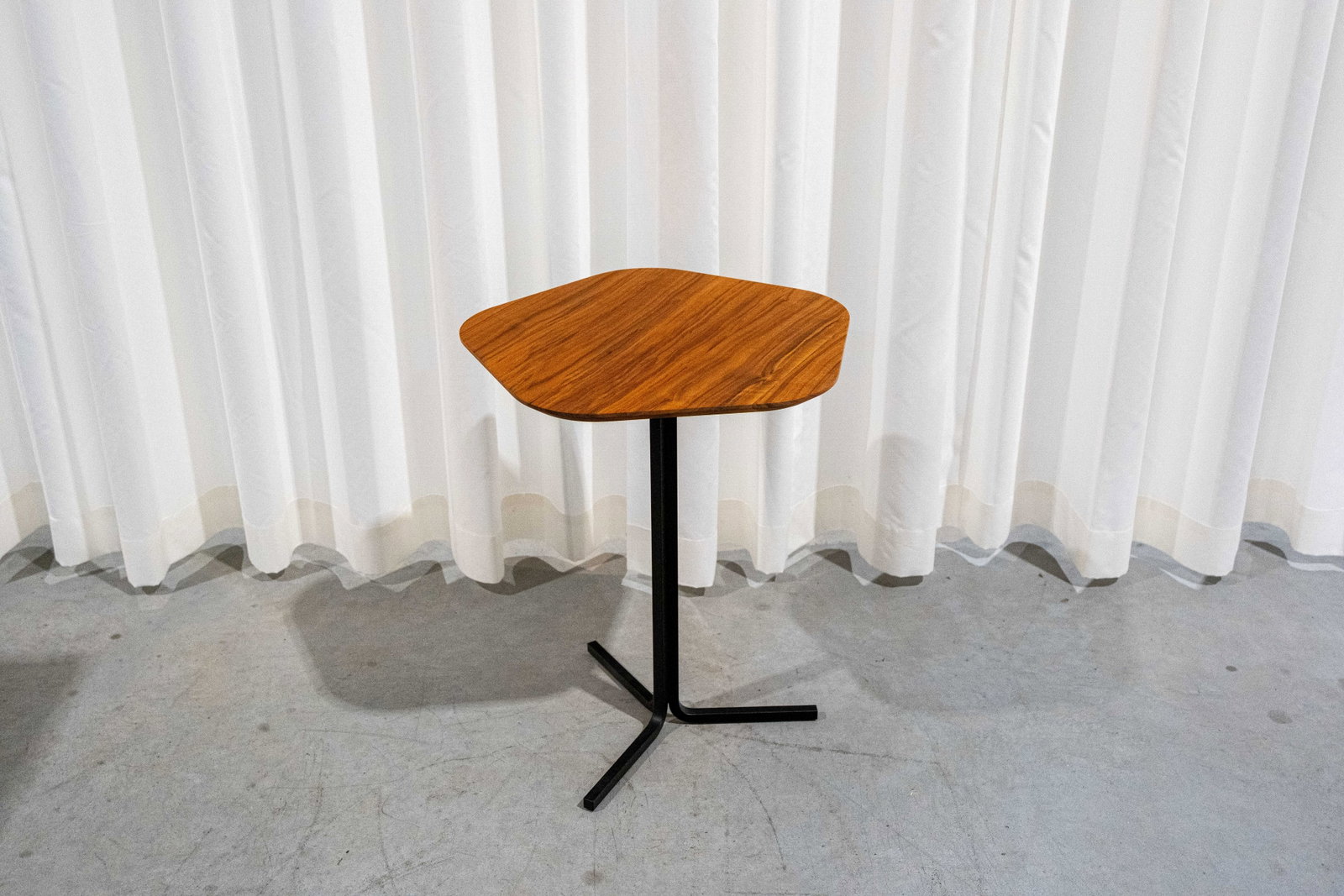 A modern walnut and steel side table modeled by Pentagono for Jori (1 of 3)