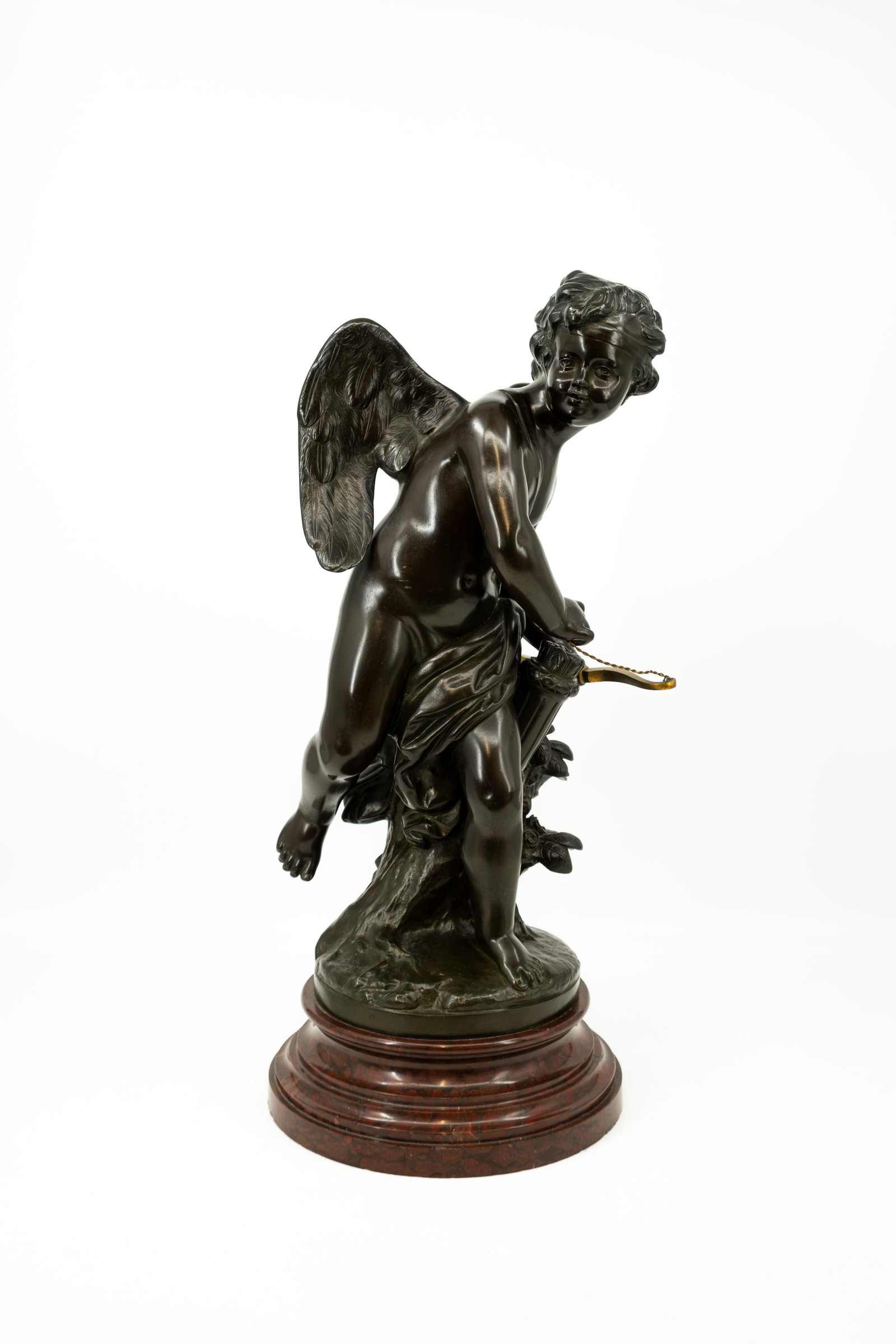 Louis-Simon BOIZOT (1743-1809) After. An antique French patinated bronze sculpture: Louis-Simon BOIZOT (1743-1809) After. An antique French patinated bronze sculpture of cupid. Footed on a red marble base. Signed "Sèvres". 19th century. Base is chipped. H: 58,5 cm, without base