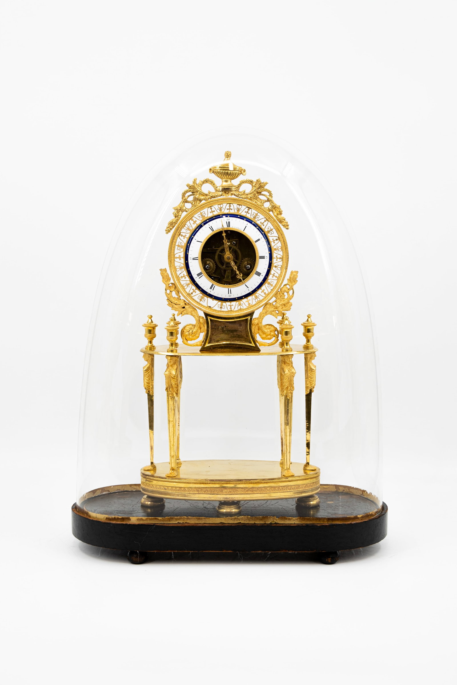 A French Empire gilt bronze skeleton clock by Chopin à Paris: A French Empire gilt bronze skeleton clock by Chopin à Paris, protected under a glass dome. Early 19th century. H: 45 - W: 23 cm, clock