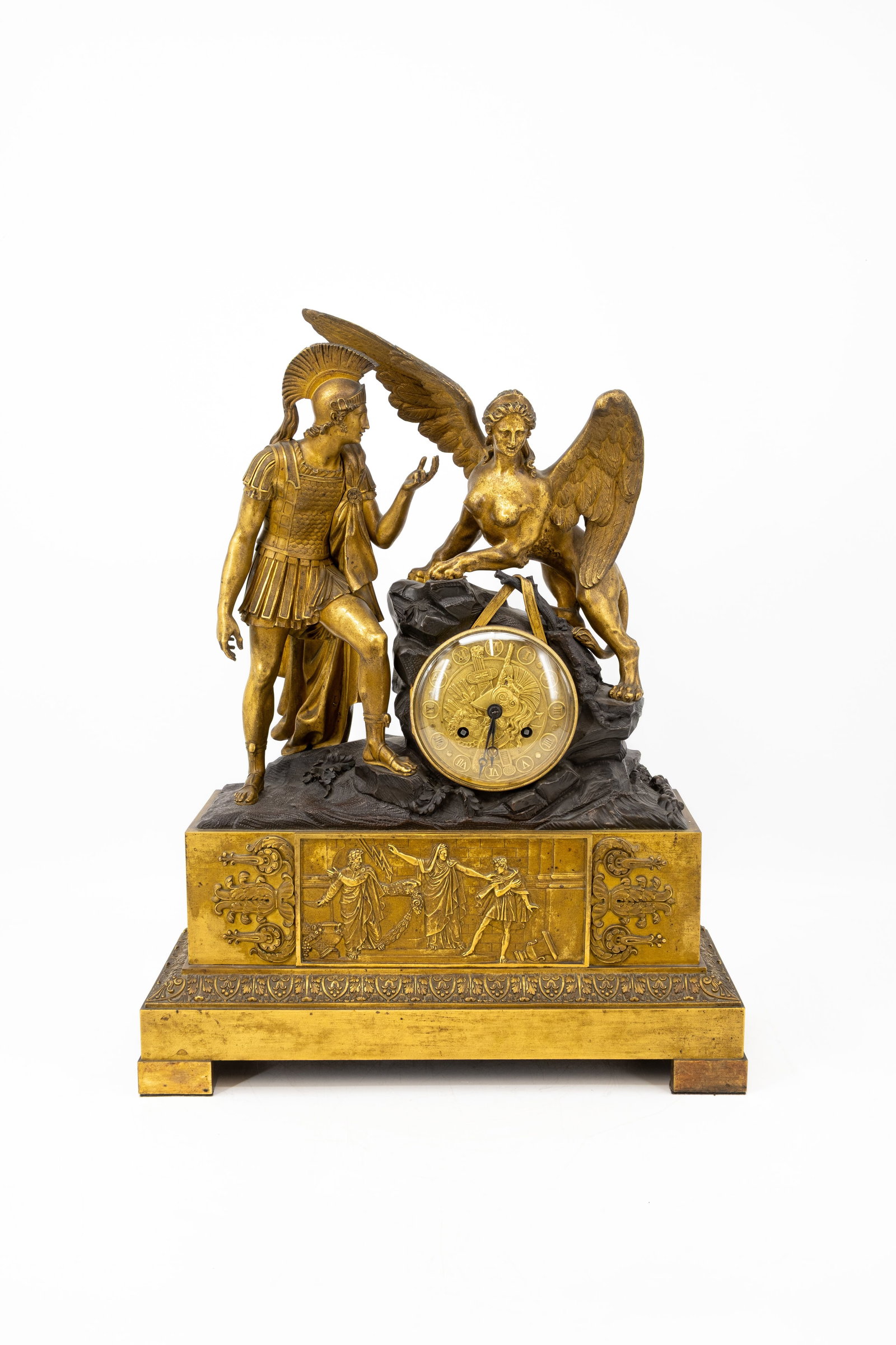 An important antique French Empire gilt bronze figural mantel clock with a mythological scene: An important antique gilt bronze French Empire figural mantel clock representing an animated mythological scene. 19th century. H: 58 - W: 45 cm