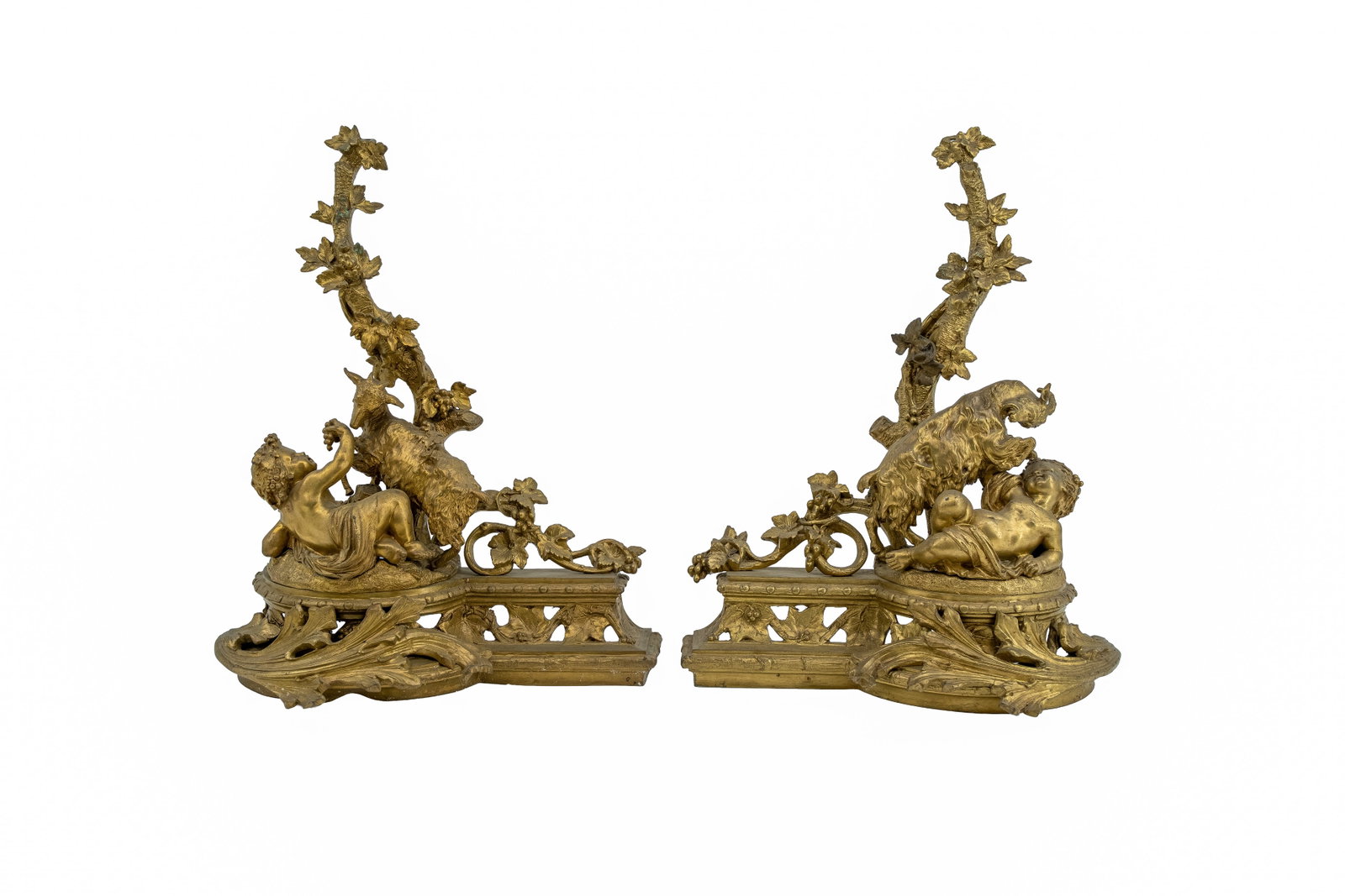 A large antique pair of Louis XV Rococo-style gilt bronze andirons with figural decoration: A large antique pair of Louis XV rococo-style gilt bronze decorated andirons with figural putti and goat. Late 19th century. H: 50 - W: 40 cm