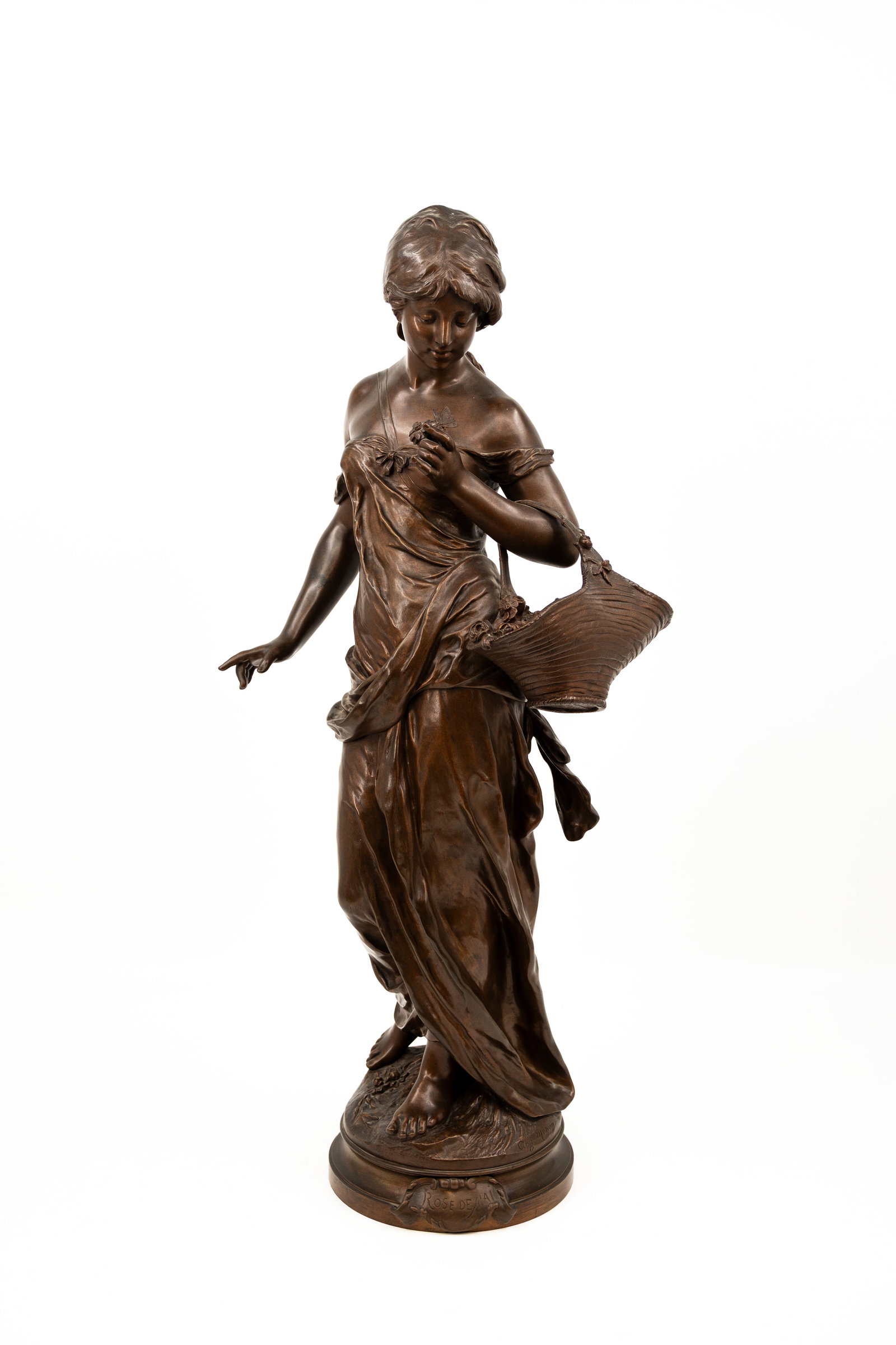 Auguste MOREAU (1834-1917) "Rose De Mai" A large antique patinated bronze sculpture: Auguste MOREAU (1834-1917) "Rose De Mai". A large antique patinated bronze sculpture of a young lady holding flowers. Footed on a rotating base. Signed, late 19th century. H: 76,5 cm