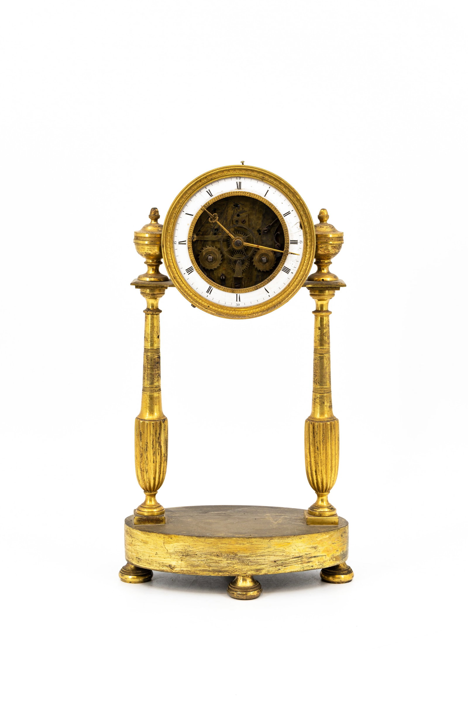 An antique French Louis XVI style gilt bronze skeleton clock: An antique French Louis XVI style gilt bronze skeleton clock. 19th century. Pendulum and key are missing. H: 34 - W: 18,5 cm