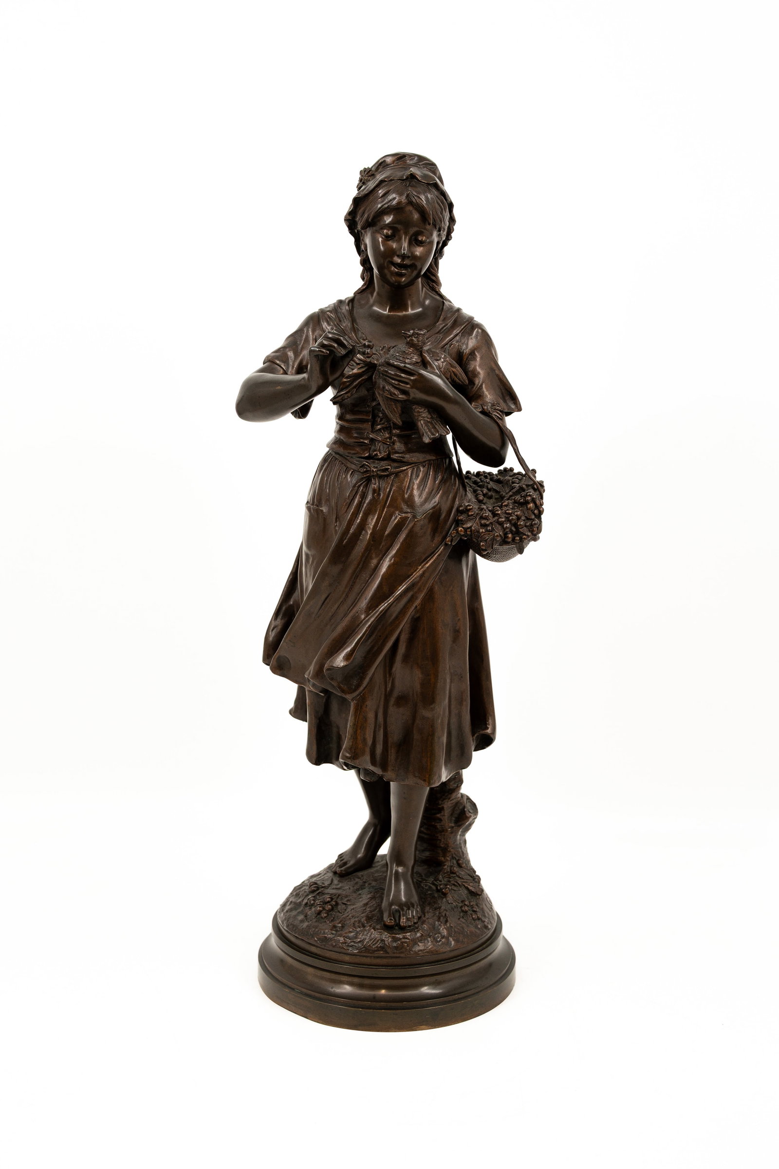 Jean-Louis GREGOIRE (1840-1890) An antique patinated bronze sculpture: Jean-Louis GREGOIRE (1840-1890) An antique patinated bronze sculpture representing a lady feeding a bird. Signed, late 19th century. H: 60 cm