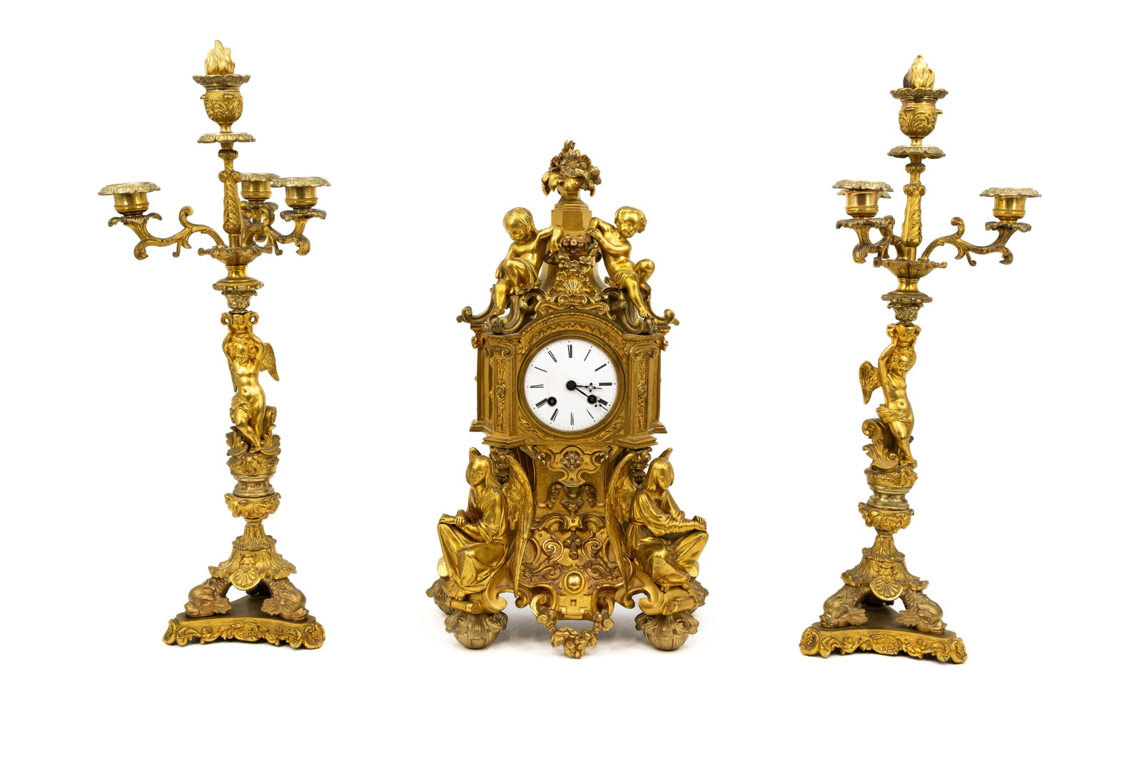 An antique matching Louis XV-style richly decorated gilt bronze mantel clock set: An antique matching Louis XV-style gilt bronze mantel clock set richly decorated with putti and angels. Late 19th century. H: 46 - W: 28 cm, clock