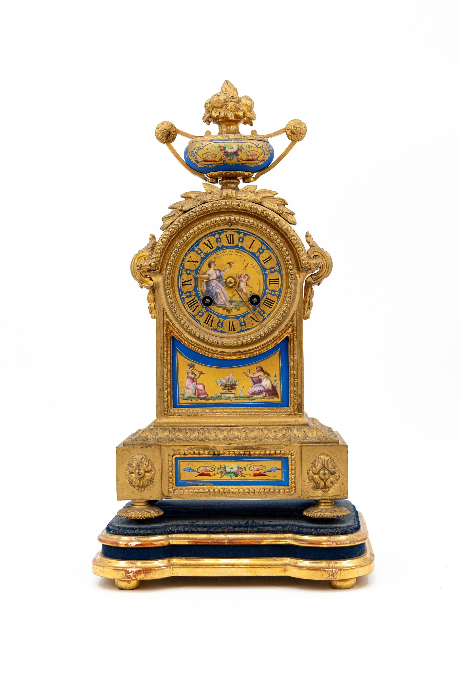An antique French Sèvres-style gilt bronze table clock with mounted decorated porcelain plaques: An antique French Sèvres-style gilt bronze table clock with mounted decorated porcelain plaques, marked by Ollivant and Botspord. Circa 1900. H: 38,5 - W: 20 cm