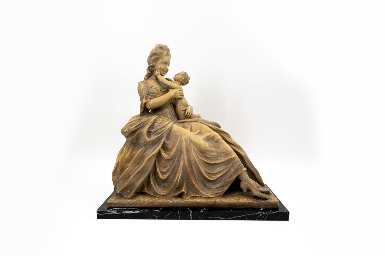 Auguste CARLI (1868-1930) A patinated terracotta group representing a lady and a child: Auguste CARLI (1868-1930) A patinated terracotta group representing a lady and a child. Mounted on a marble base. Signed and marked "Made In Belgium 2171". First half 20th century. H: 45 - W: 46,5 cm