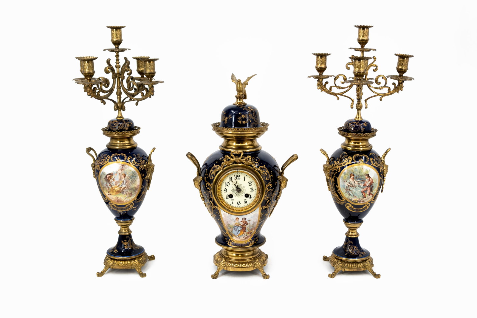 An antique French Louis XVI Sèvres-style mantel clock set in decorated porcelain and gilt brass: An antique French Louis XVI Sèvres-style mantel clock set in decorated porcelain and gilt brass. Circa 1900. H: 51 - W: 28 cm, clock