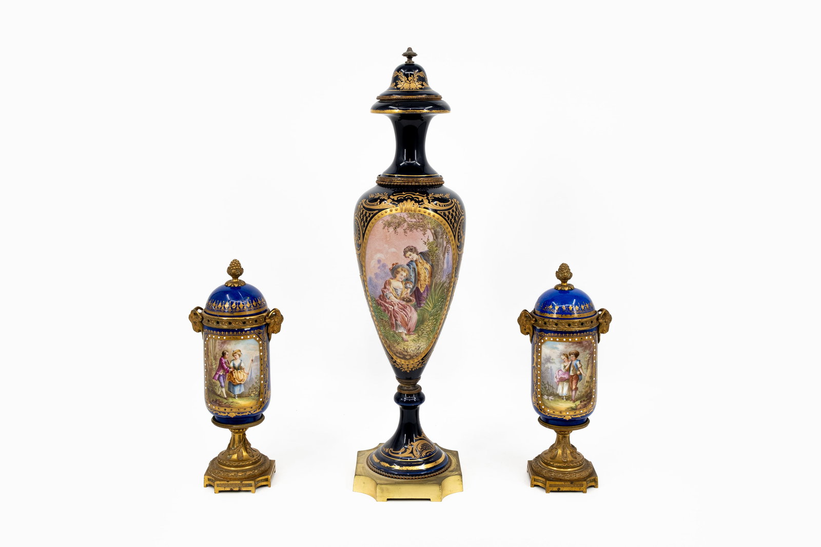 A lot of three antique French Sevres style brass mounted cobalt blue porcelain covered vases: A lot of three antique French Sevres style brass mounted cobalt blue porcelain covered vases decorated with romance scenes. Marks, 19th/20th century. Condition: two covers have damage, report availabl
