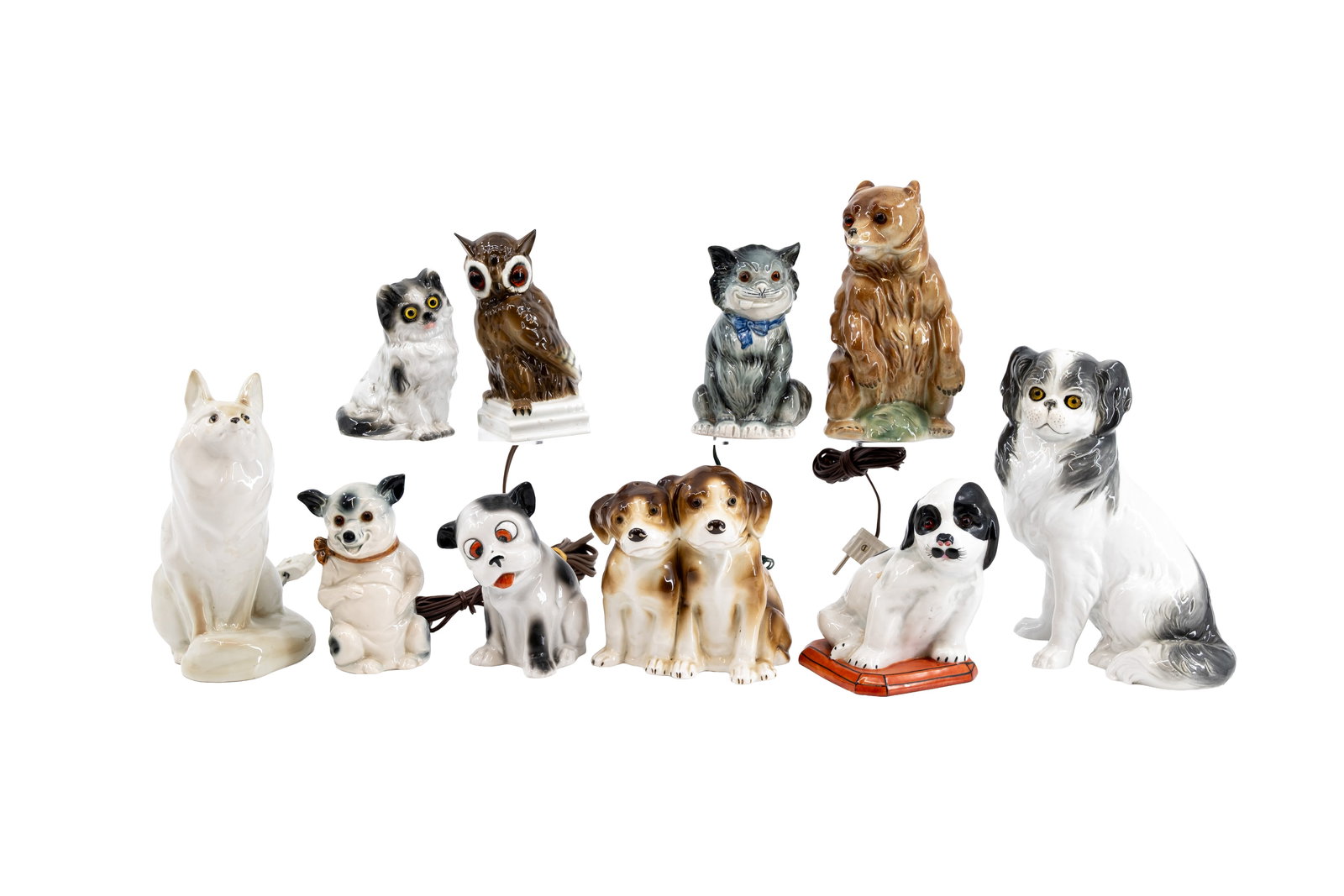A composed lot of 10 antique porcelain figural perfume table lamps: A composed lot of 10 antique porcelain figural perfume table lamps. Four dog-shaped, two cat-shaped, one bear-shaped, one owl-shaped, one pig-shaped and one fox-shaped. First half 20th century. H: 13,