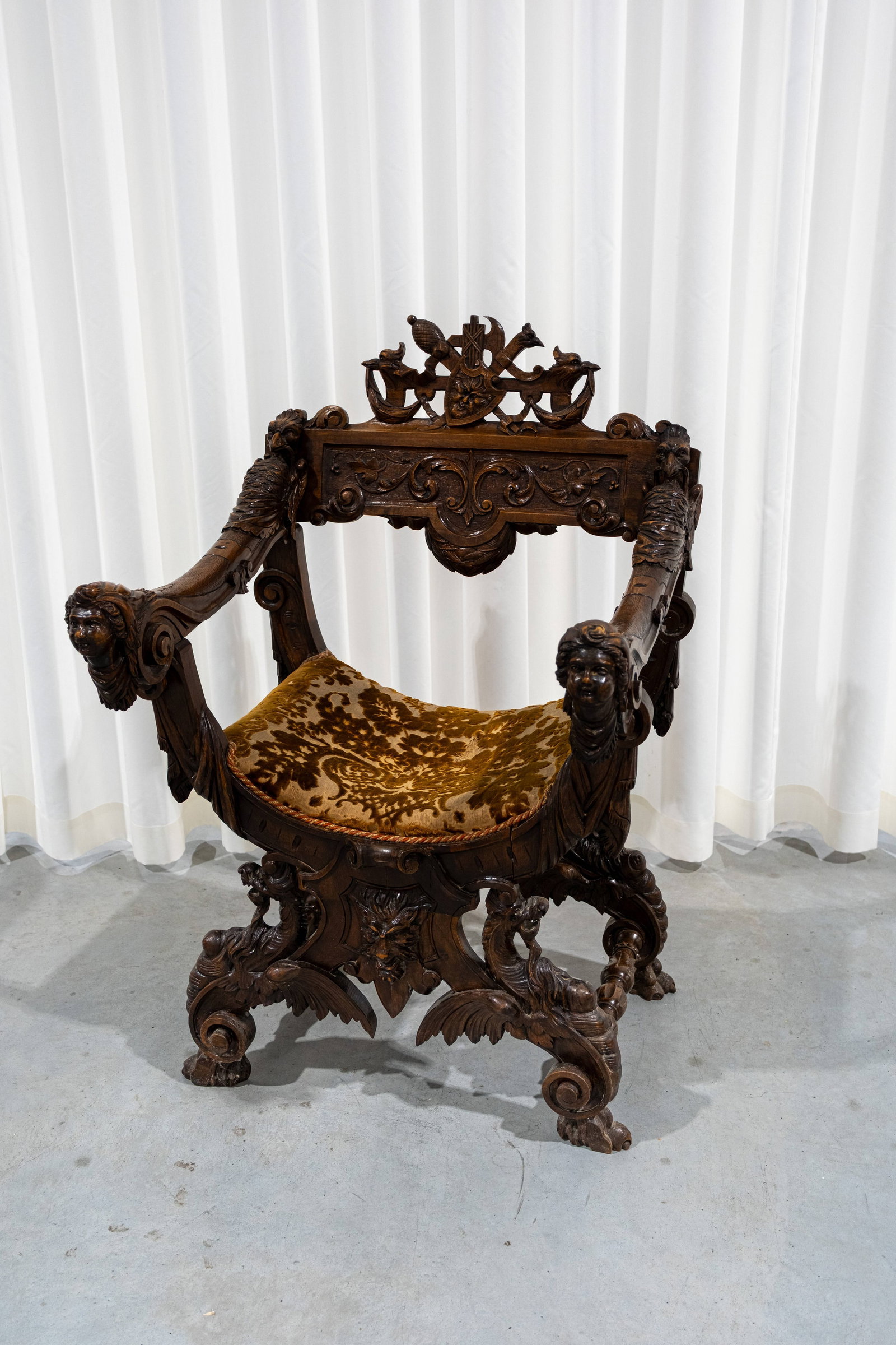 An antique Italian richly decorated carved walnut armchair (1 of 11)