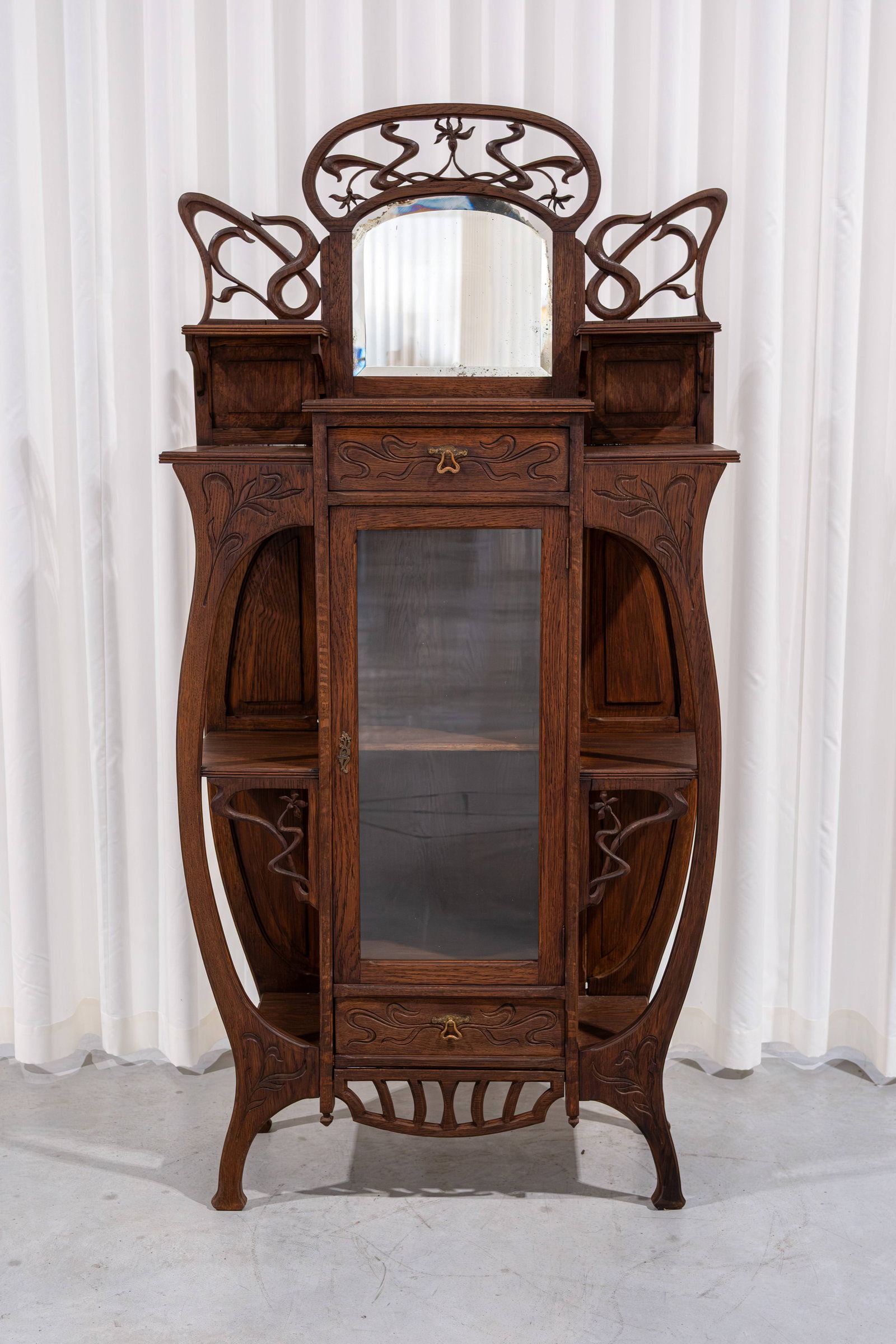 An art nouveau richly decorated wooden display cabinet: An art nouveau richly decorated wooden display cabinet. Circa 1900-1920s. H: 185 - W: 94 - D: 35 cm