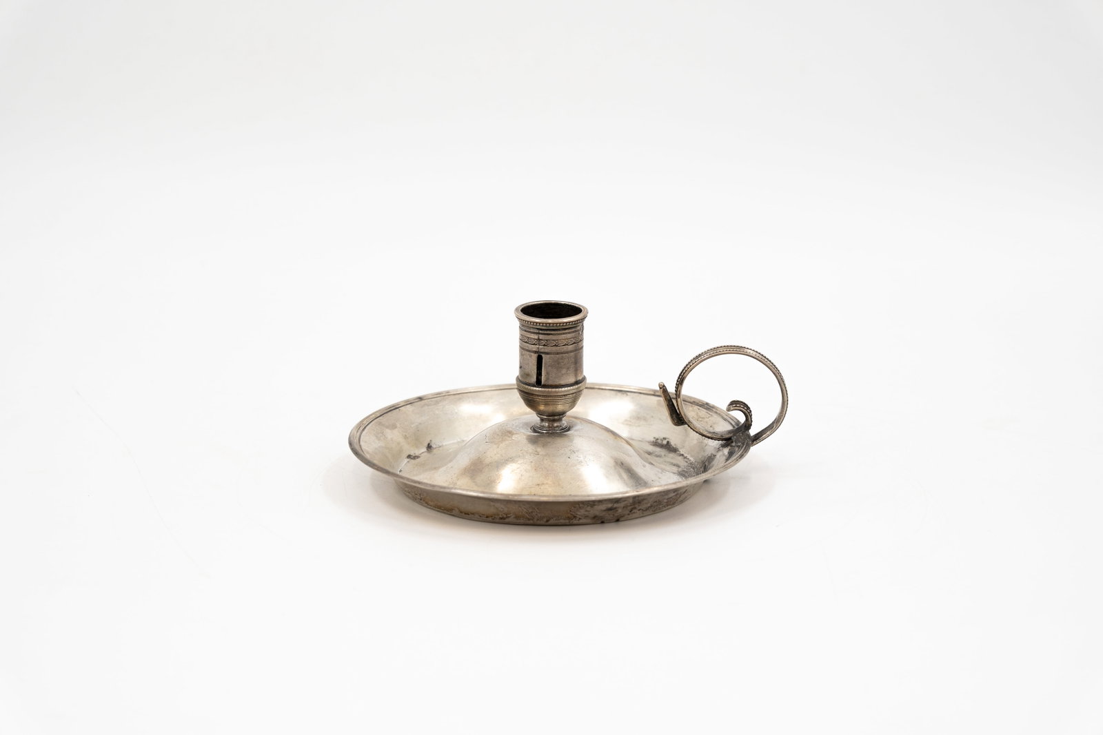 An antique silver candle holder. (1 of 9)