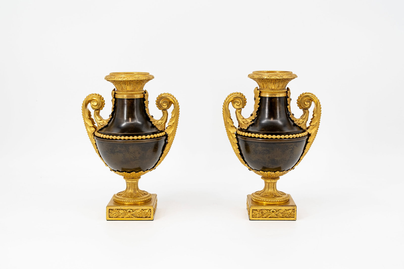 A pair of antique Louis XVI gilt and patinated finely chiseled bronze vases: A pair of antique Louis XVI gilt and patinated finely chiseled bronze vases. Comes with a document of provenance with written: Epoque Louis XVI period. Probably 18th century. H: 24 cm