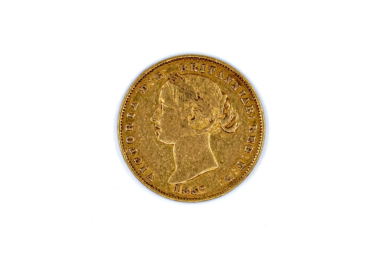 An Australian gold Sovereign coin of Victoria, dated 1857: An Australian gold Sovereign coin of Victoria, dated 1857. With head of young Queen Victoria on the obverse, and crowned denomination within wreath on the reverse. Weight: 8g