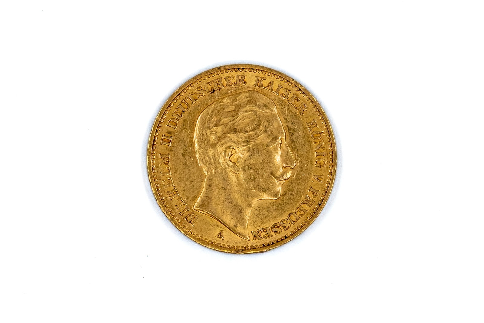 A German gold 20 Mark coin of Wilhelm II, dated 1900: A German gold 20 Mark coin of Wilhelm II, dated 1900. With head of Wilhelm II on the obverse, and imperial eagle on the reverse. Weight: 8g