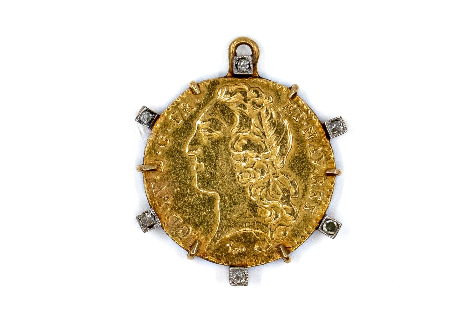 A French gold louis d'or of Louis XV, dated 1743, mounted: A French gold louis d'or of Louis XV, dated 1743, mounted in a pendant fitting highlighted with small rose-cut diamonds. With laureate head of Louis XV left on the obverse, and crowned oval shields of