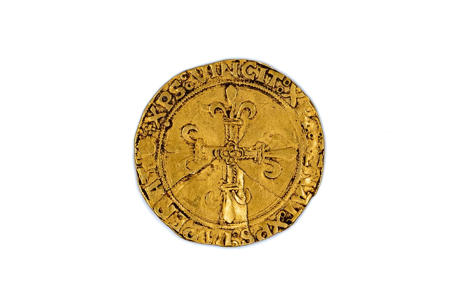 A French gold coin of François I, Dauphiné: A French gold coin of François I, Dauphiné. With cross fleurée incorporating fleurs-de-lis and dauphins on the obverse, and quartered arms within inner border and surrounding legend on the reverse.