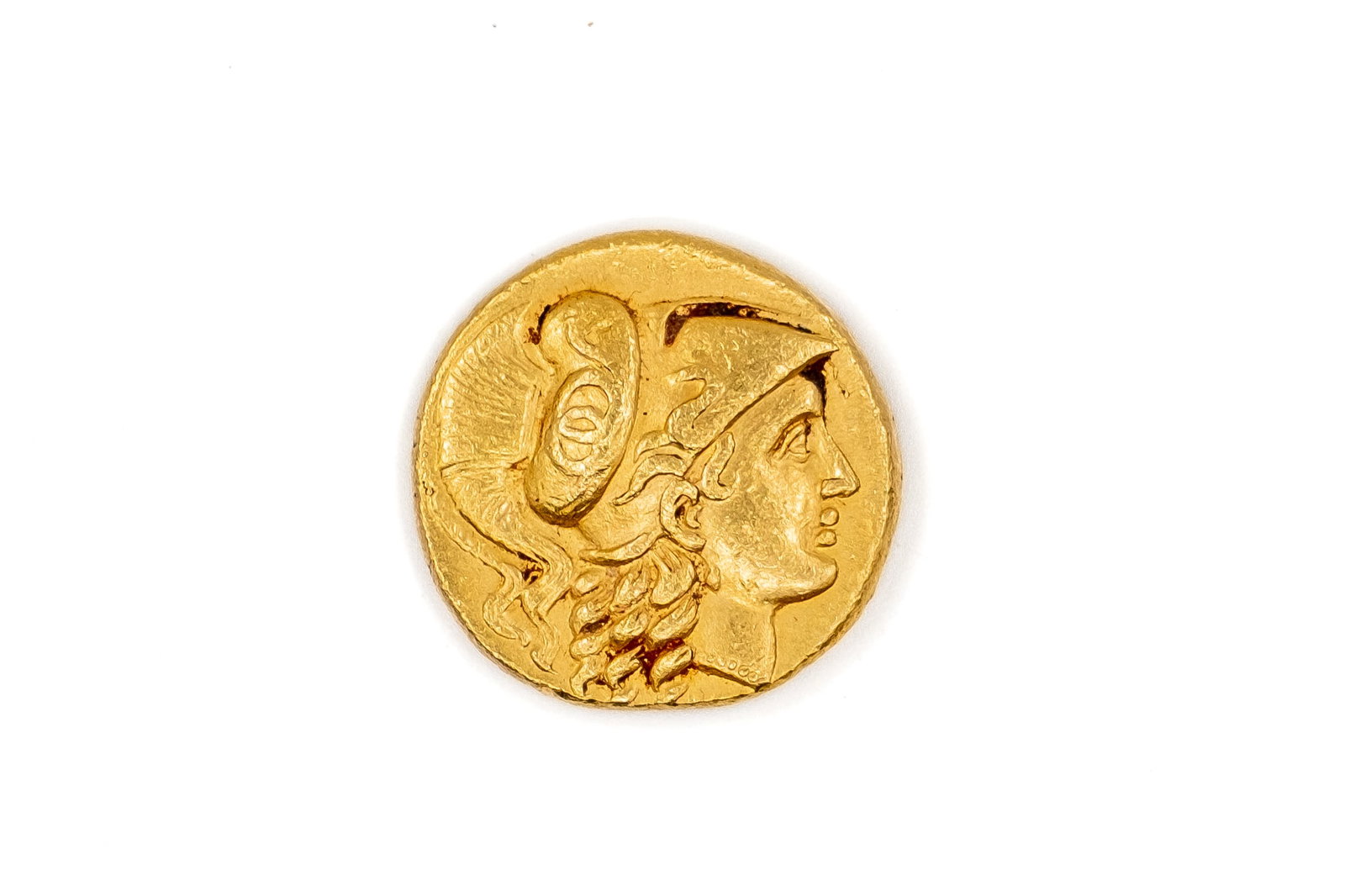 A Greek gold stater coin of Alexander III the Great, late 4th-3rd century BC: A Greek gold stater coin of Alexander III the Great, late 4th-3rd century BC. With helmeted head of Athena obverse, the reverse with Nike standing, holding wreath and stylis. Weight: 8,4g