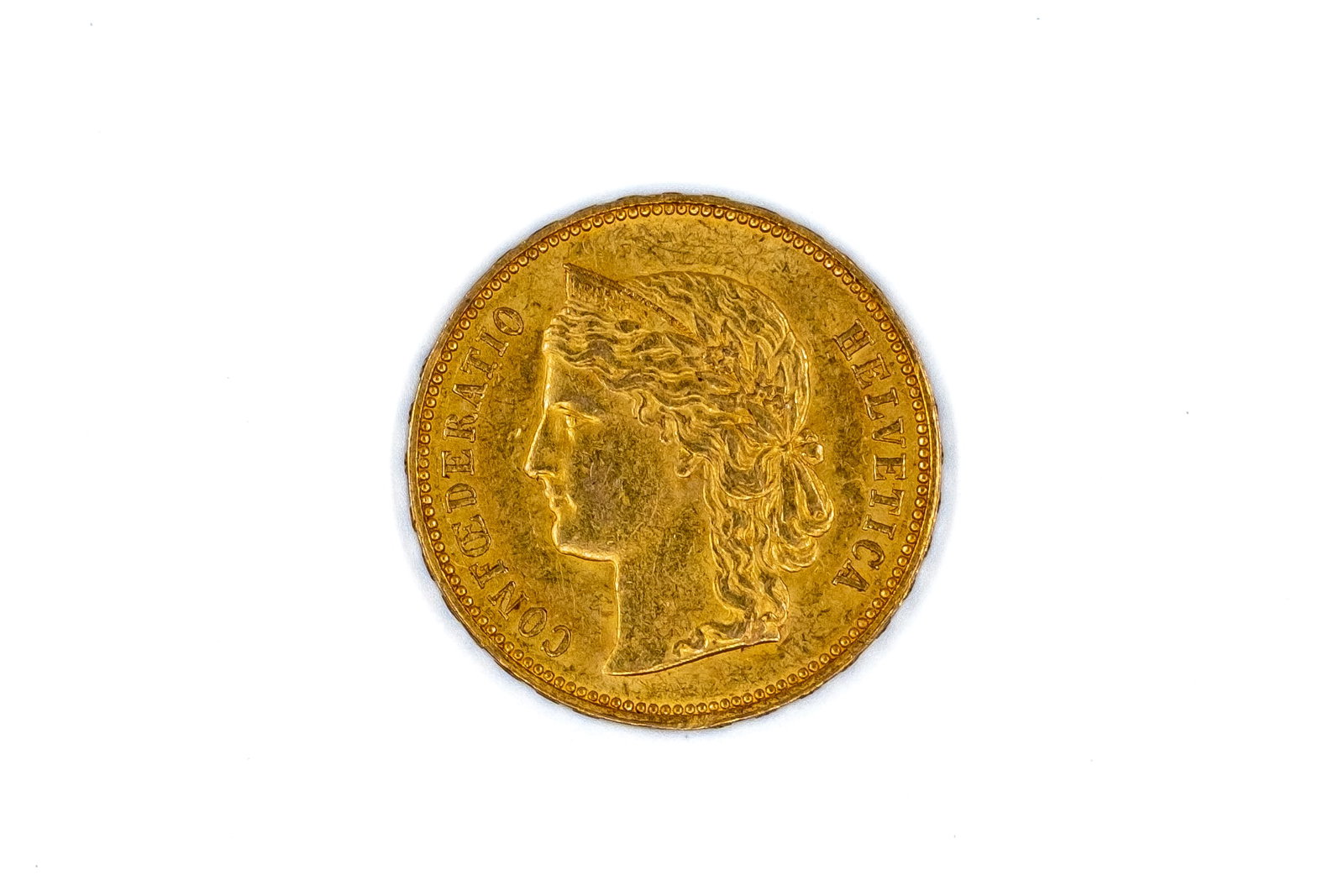 A Swiss gold 20 Francs coin, Helvetia type, dated 1889: A Swiss gold 20 Francs coin, Helvetia type, dated 1889. With head of Helvetia on the obverse, and Swiss shield within wreath on the reverse. Weight: 6,5g