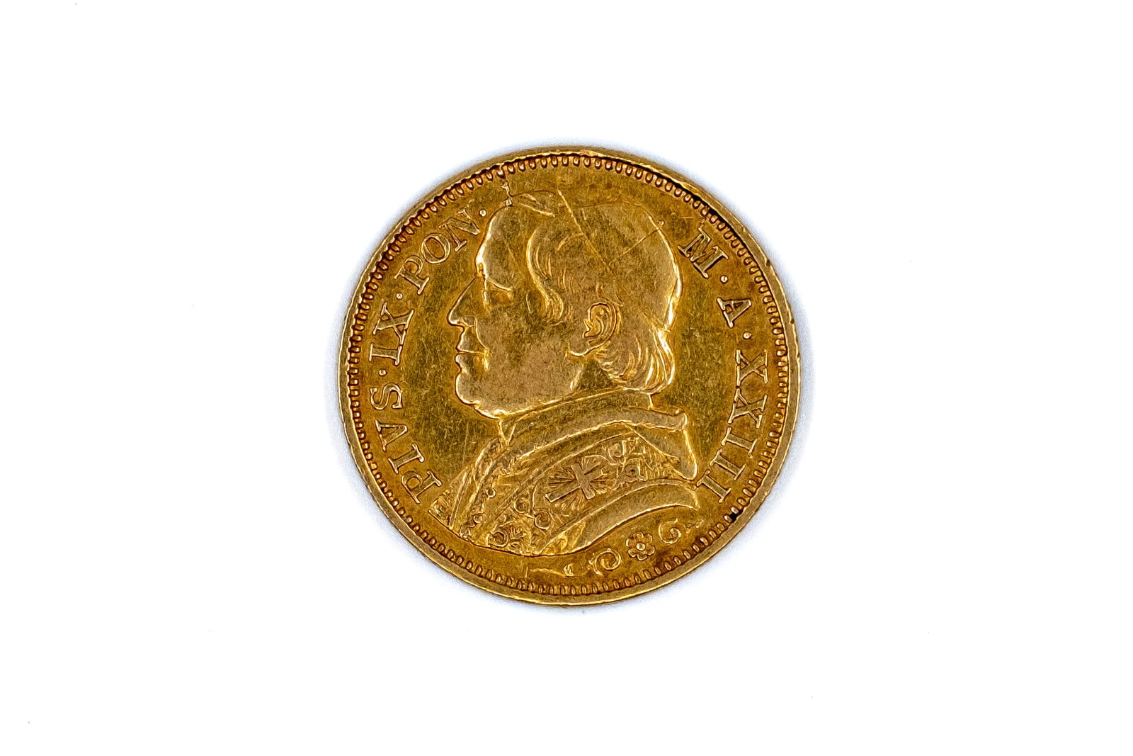 A Vatican gold 20 Lire coin of Pius IX, dated 1869: A Vatican gold 20 Lire coin of Pius IX, dated 1869. With bust of Pius IX on the obverse, and denomination within wreath on the reverse. Weight: 6,4g