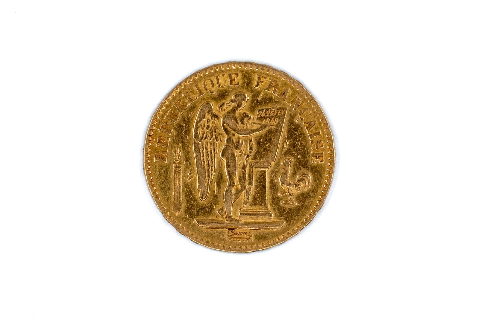 A French gold 20 Francs coin of the Second Republic, Genie type, dated 1848: A French gold 20 Francs coin of the Second Republic, Genie type, dated 1848. With standing winged Genius writing the Constitution on the obverse, and denomination within wreath on the reverse. Weight: