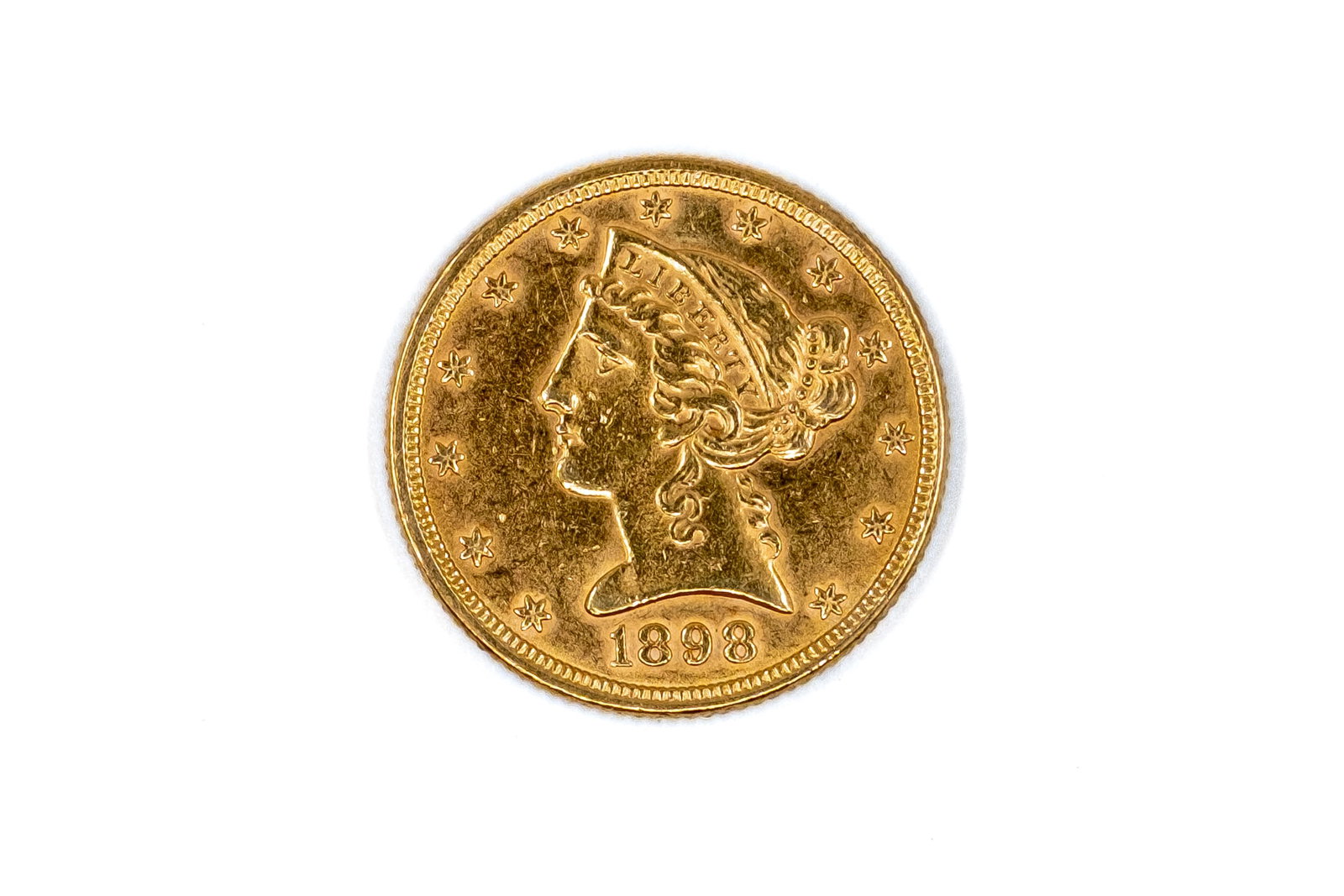 A United States gold Five Dollars coin, Liberty Head type, dated 1898: A United States gold Five Dollars coin, Liberty Head type, dated 1898. With head of Liberty on the obverse, and eagle with shield on the reverse. Weight: 8,4g