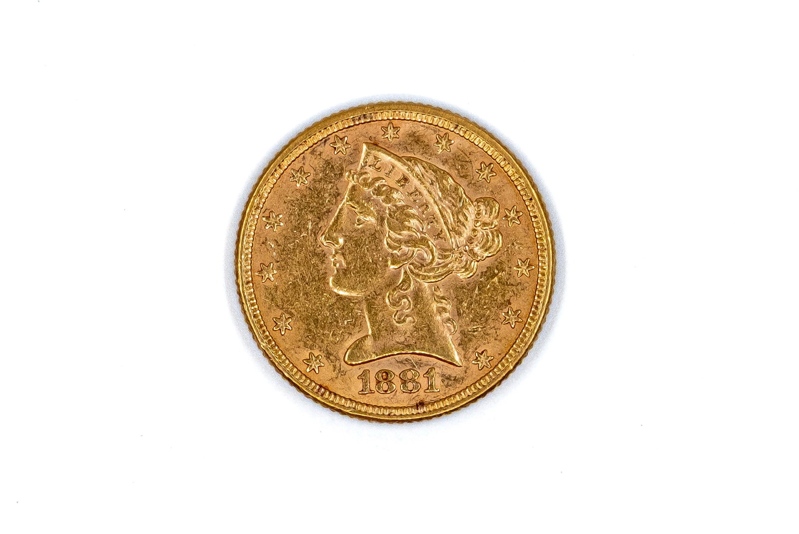 A United States gold Five Dollars coin, Liberty Head type, dated 1881: A United States gold Five Dollars coin, Liberty Head type, dated 1881. With head of Liberty on the obverse, and eagle with shield on the reverse. Weight: 8,4g