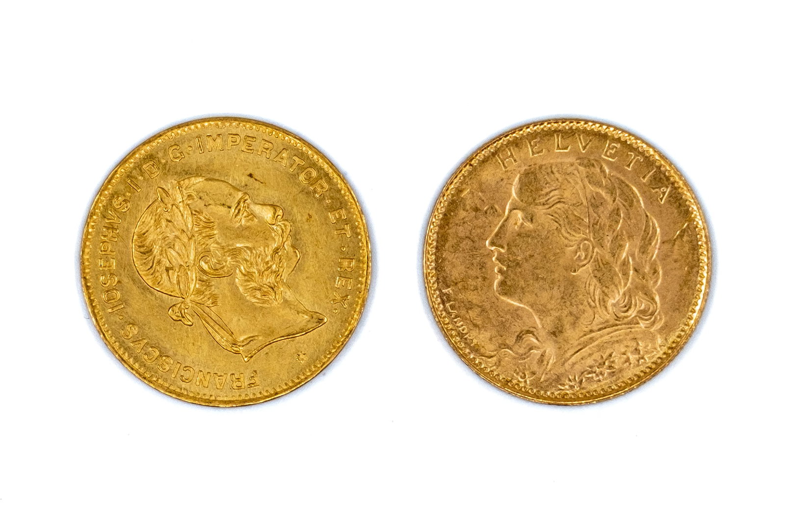 A lot of two gold 10 franc coins from various countries, dated 1892 and 1922: A lot of two gold 10 franc coins from various countries, dated 1892 and 1922. Comprising an Austrian gold 4 florins / 10 francs restrike, Franz Joseph I, dated 1892, and a Swiss gold 10 francs, Confed
