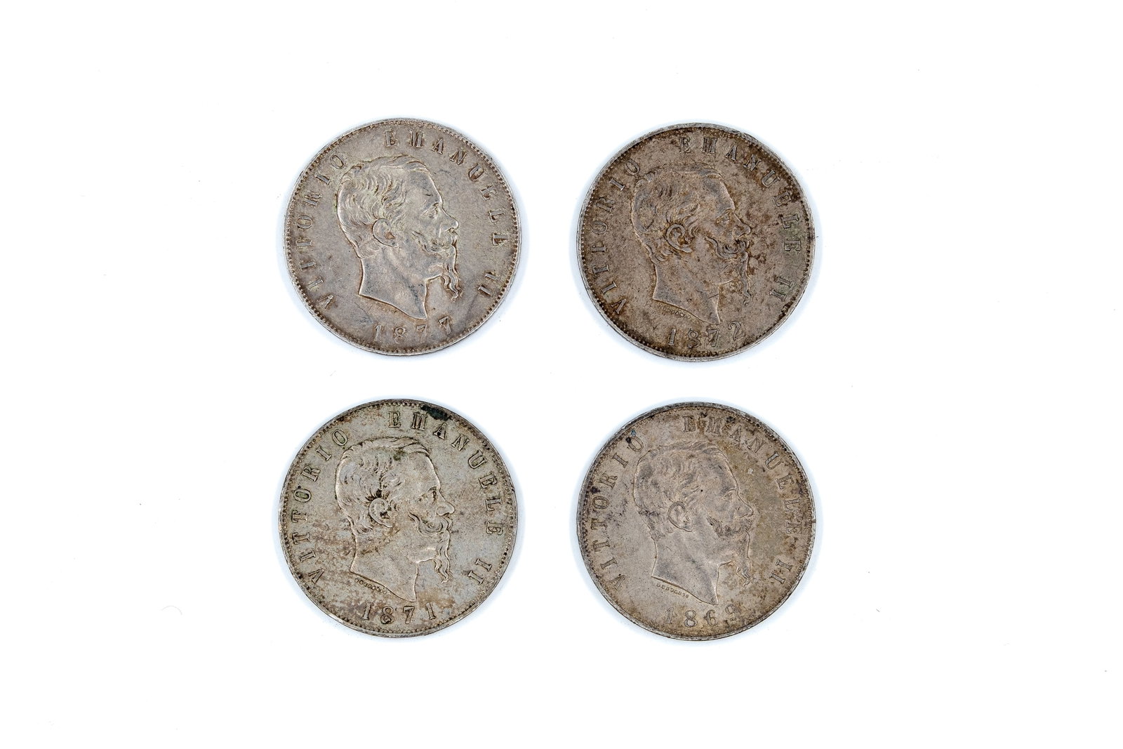 A lot of four Italian silver 5 Lire coins of Vittorio Emanuele II: A lot of four Italian silver 5 Lire coins of Vittorio Emanuele II, dated 1869, 1871, 1872, and 1877. With portrait of the king on the obverse and crowned Savoy shield within wreath on the reverse. Tot