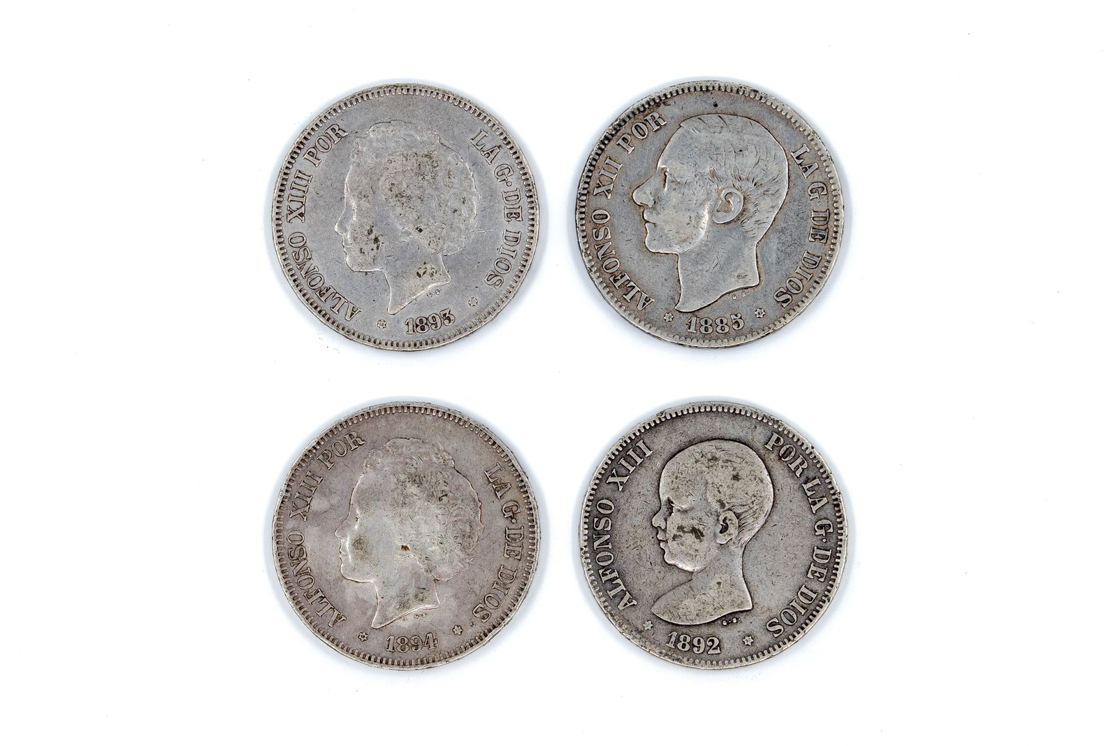 A lot of four Spanish silver 5 Pesetas coins of Alfonso XII and Alfonso XIII: A lot of four Spanish silver 5 Pesetas coins of Alfonso XII and Alfonso XIII, dated 1885-1894. With portraits of the kings on the obverse. Reverse with crowned Spanish coat of arms and denomination. T